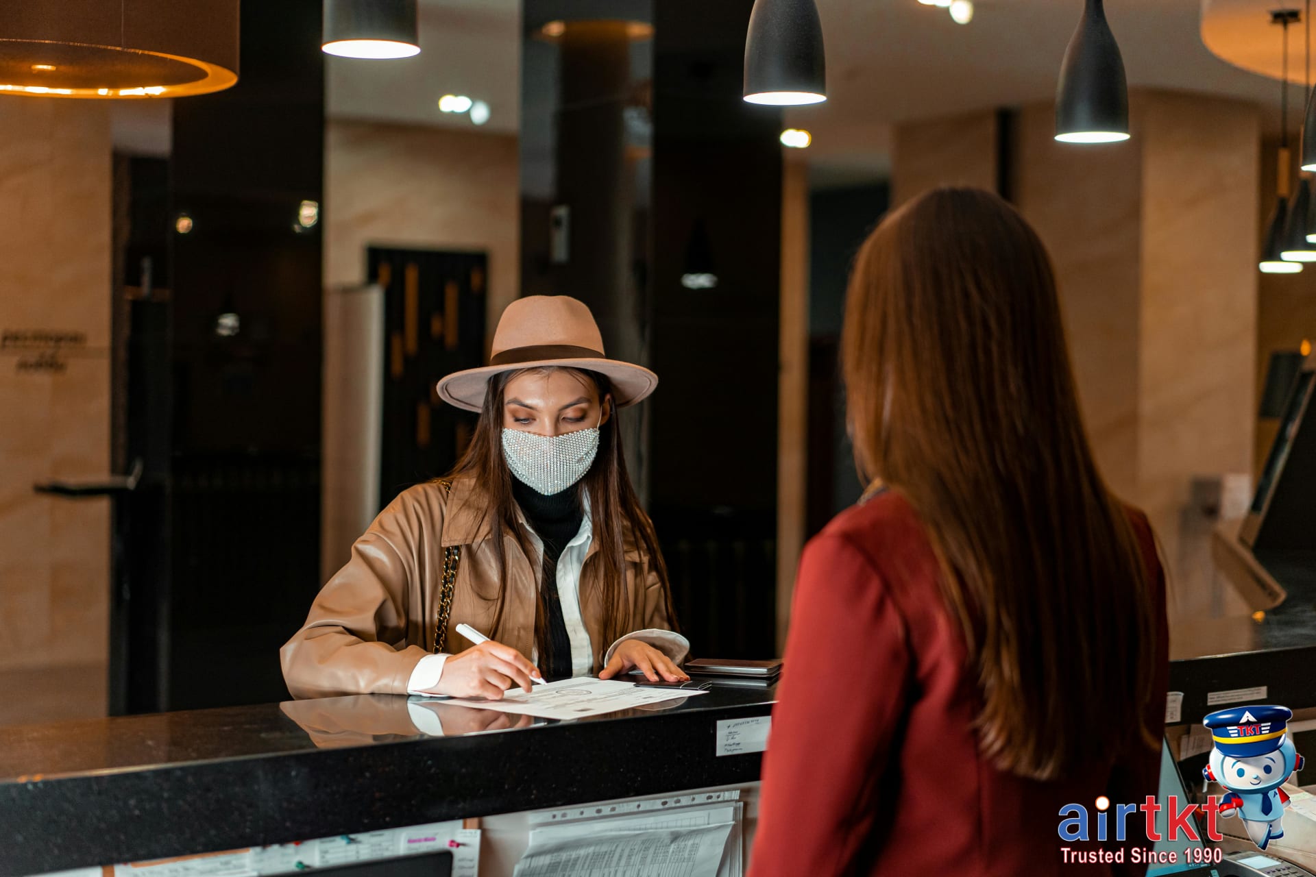 Traveler talking to hotel staff at reception
