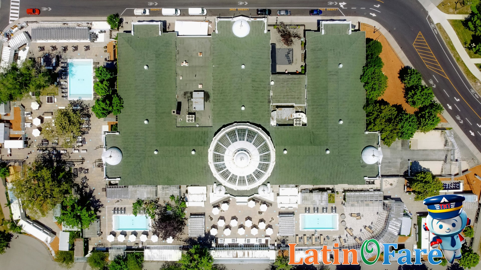 Aerial view of resort with green roofs and pools