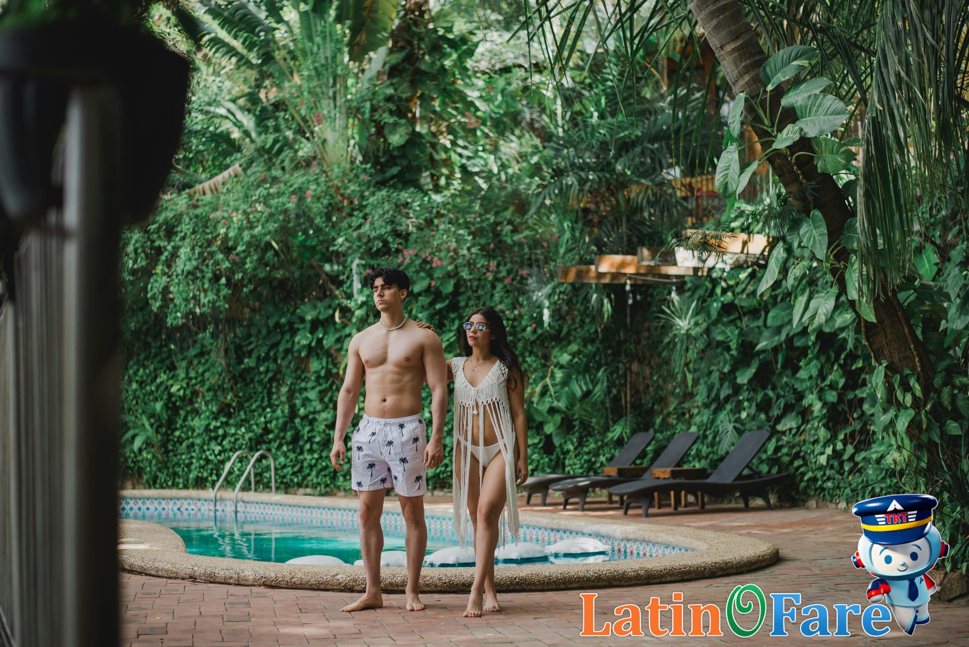Young couple relaxing by tropical resort poolside