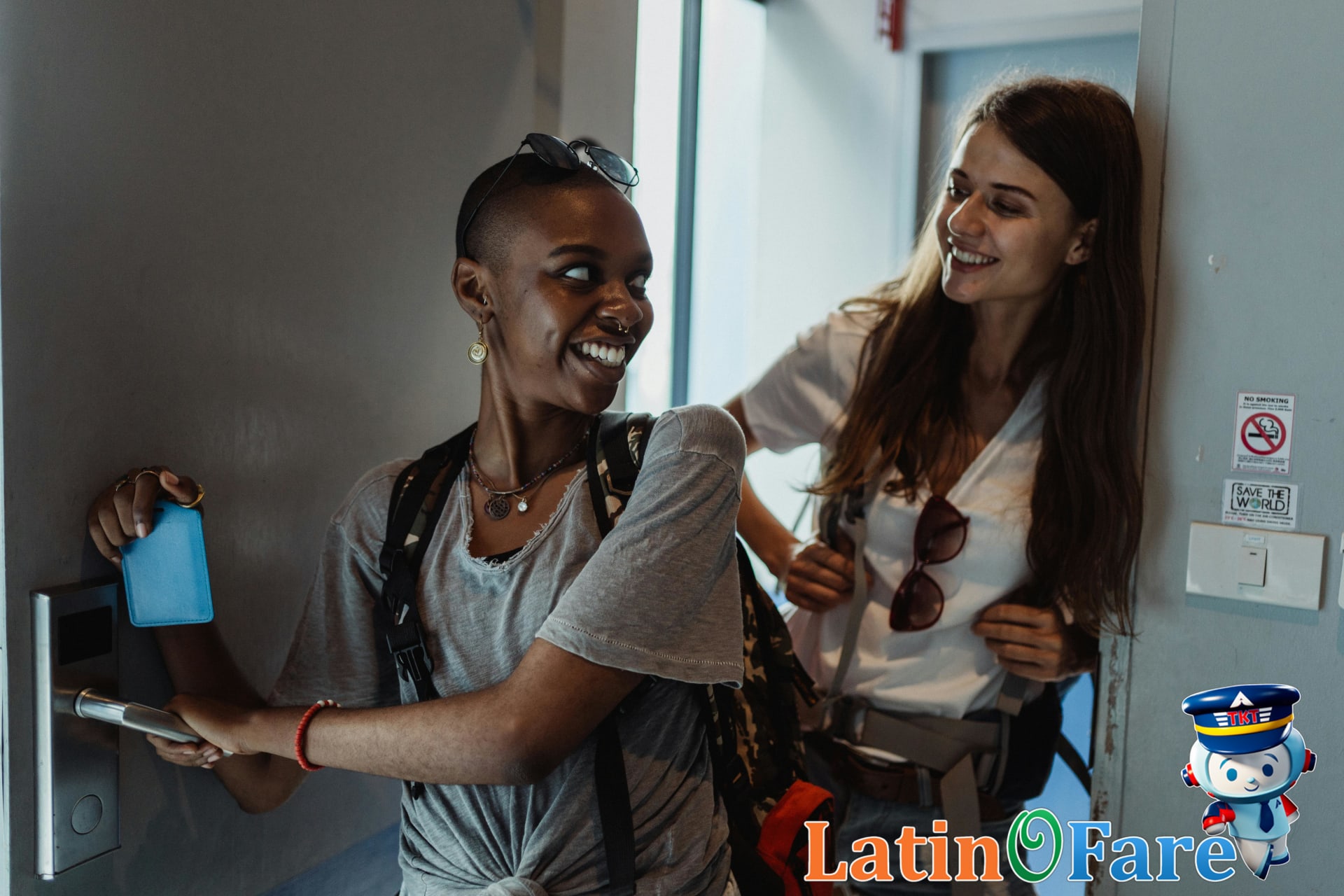 Traveler holding hotel room key after booking last-minute hotel deal in modern lobby