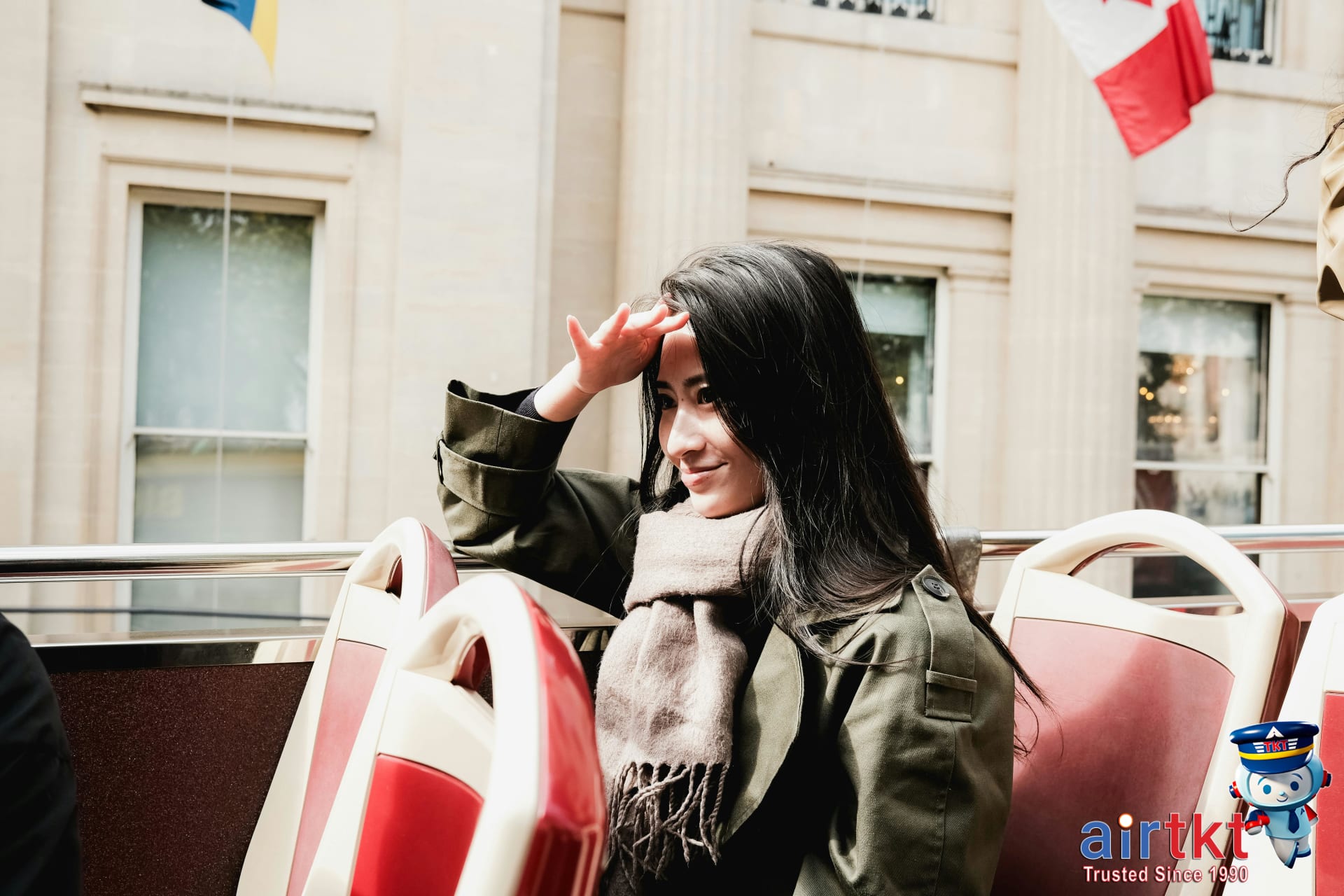 Happy traveler embracing Canadian customs on a city tour bus representing cultural appreciation