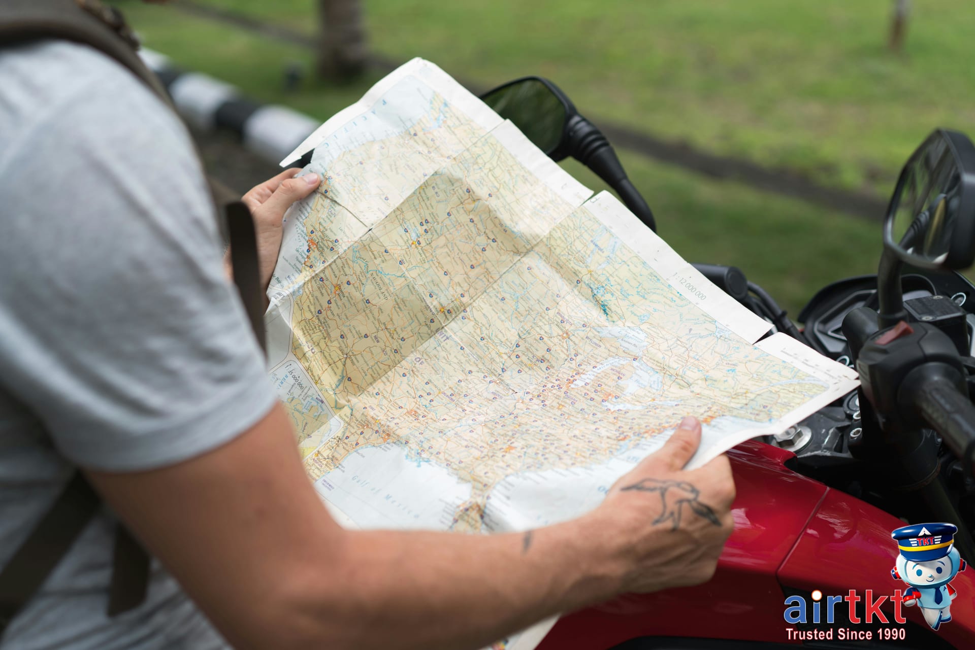Traveler checking map for Costa Rica travel tips outdoors with backpack gear