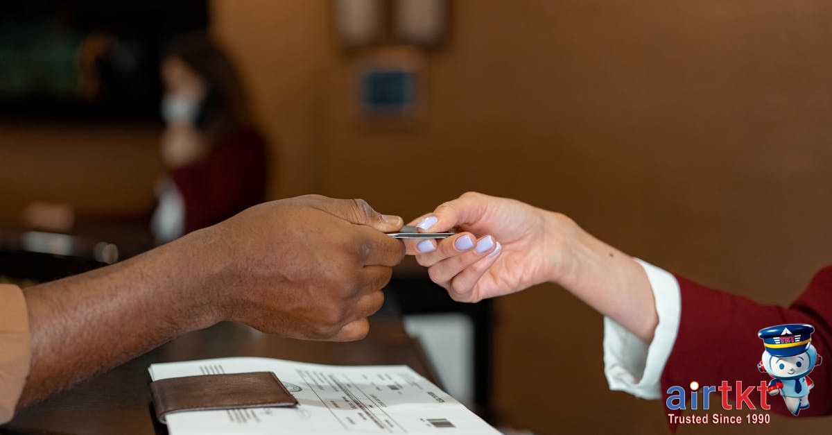 Traveler carefully choosing cards to pay at checkout abroad