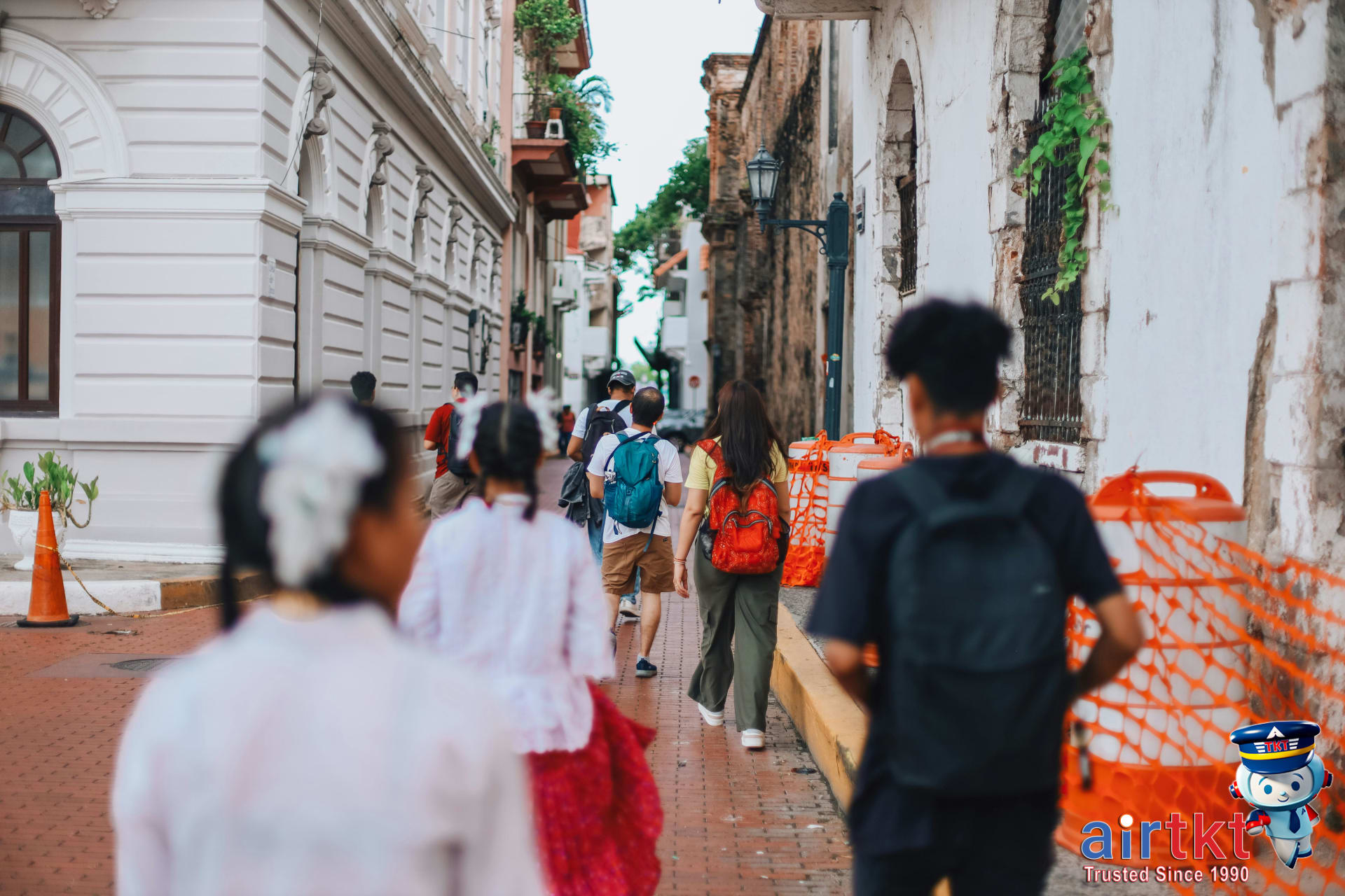 Traveler securing backpack from pickpocket theft in crowded market area