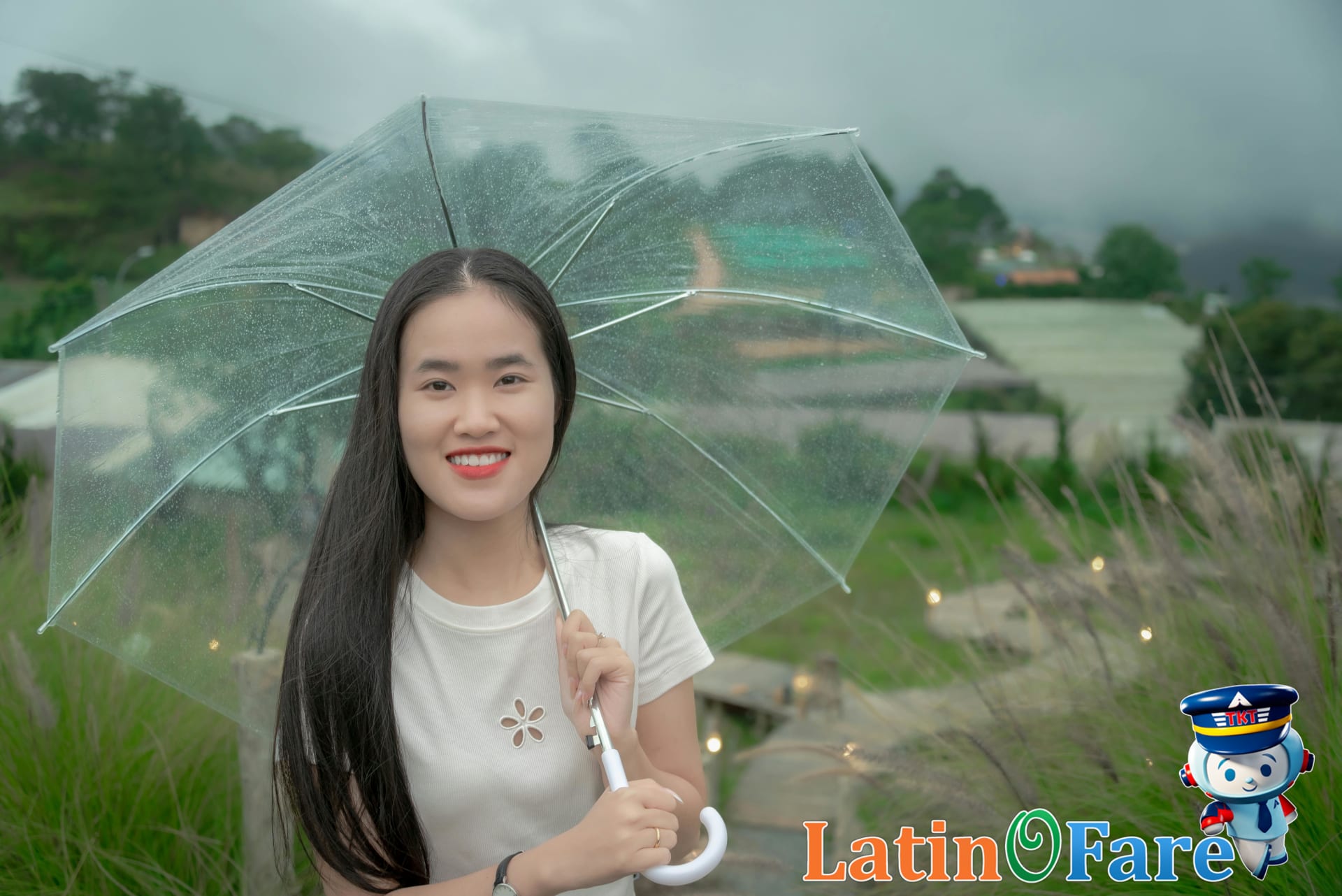 Traveler enjoying rainforest views during Costa Rica green season with light rain and vibrant scenery.