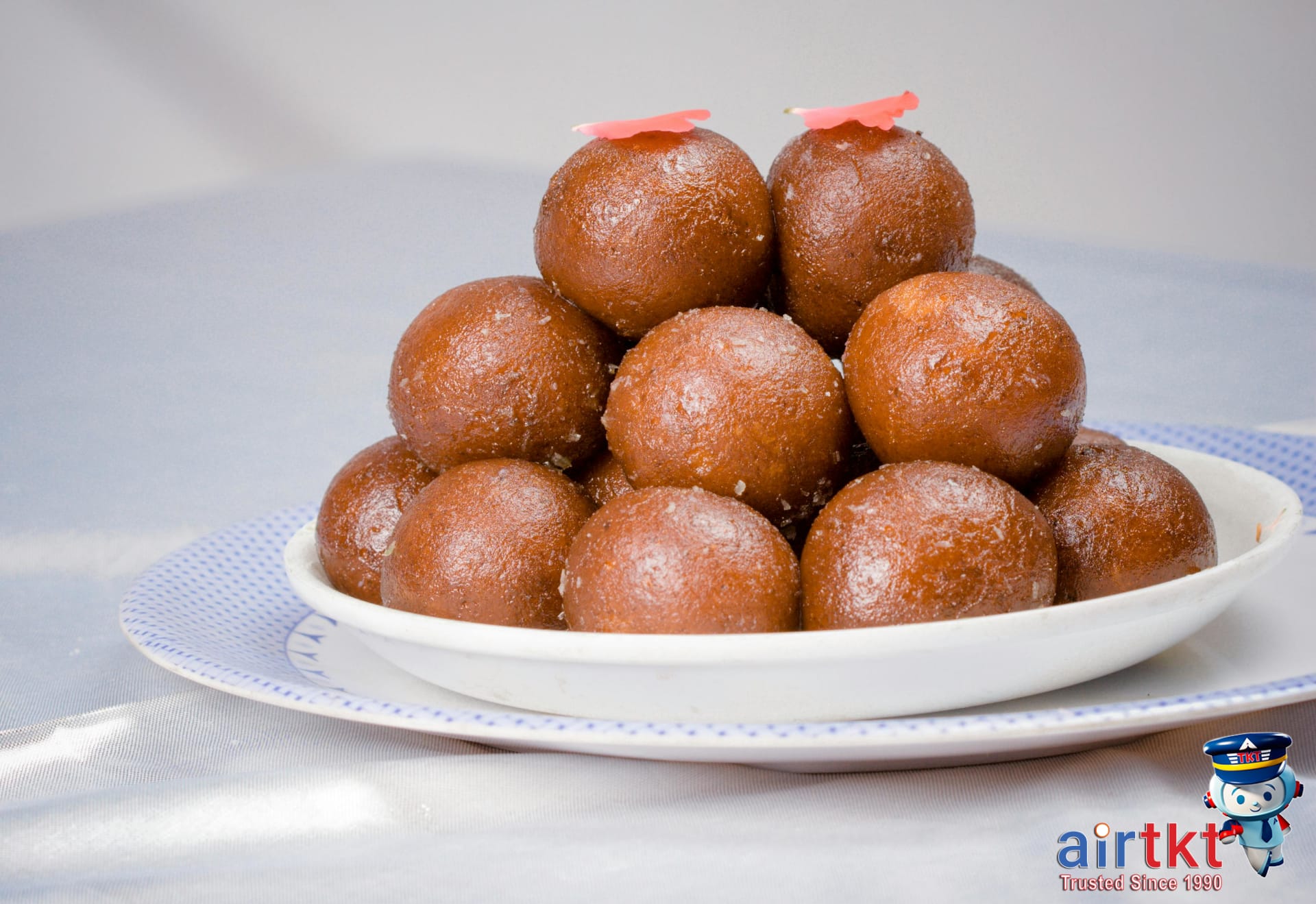 Close-up of traditional Holi sweet Gulab Jamun on white plate