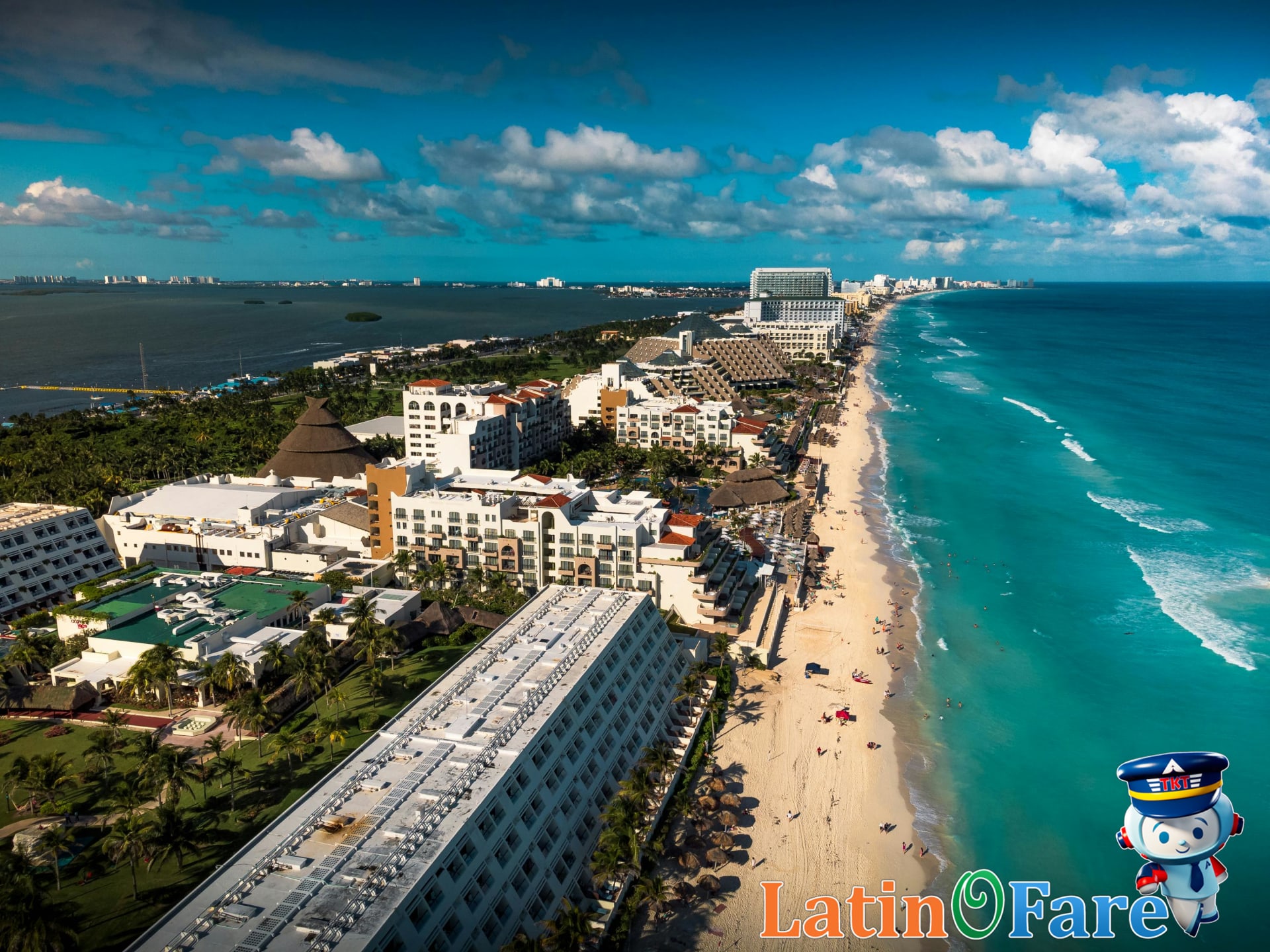 Aerial view of Cancun beach with palm trees and turquoise water on spring break