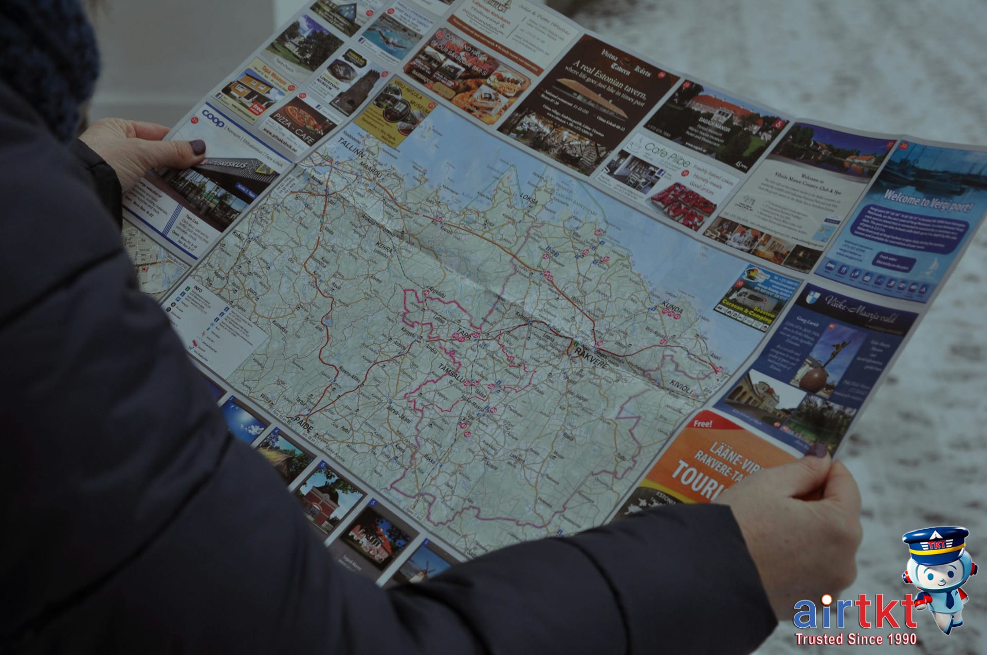Tourists using maps and guides to navigate Mardi Gras festivities in New Orleans streets