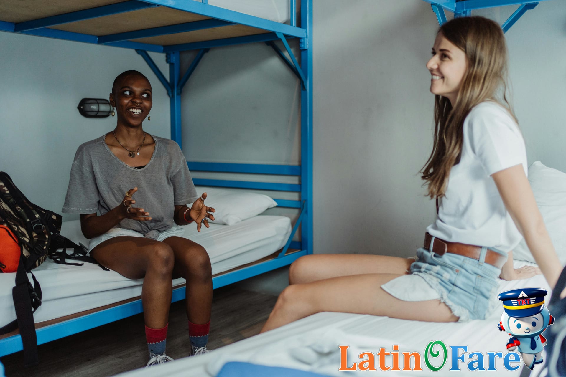 Two women enjoying downtime in a cozy hostel room with bunk beds for backpackers after budgeting their Gringo Trail trip