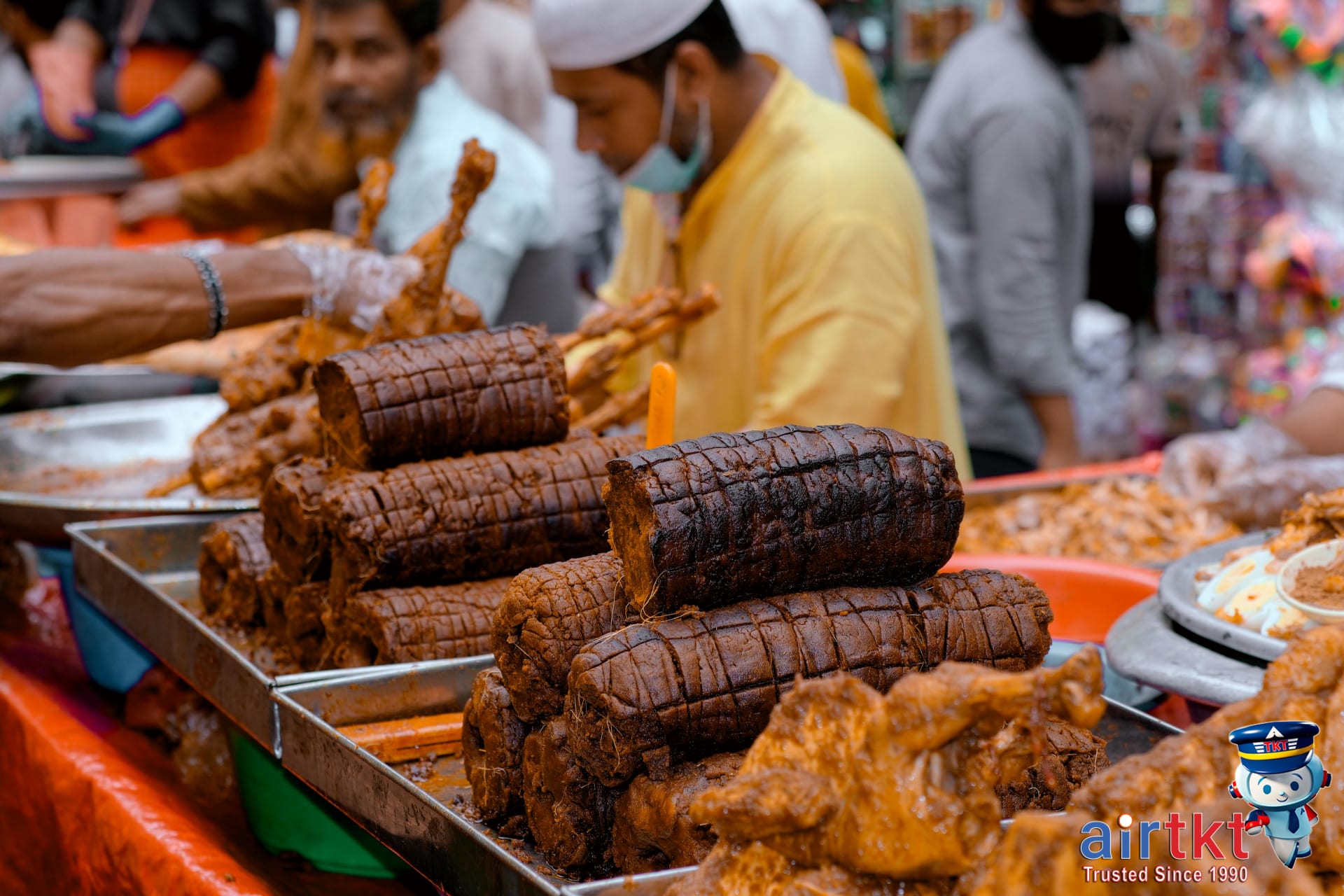 Halal food stalls in busy market serving Muslim-friendly halal dining during Eid travel
