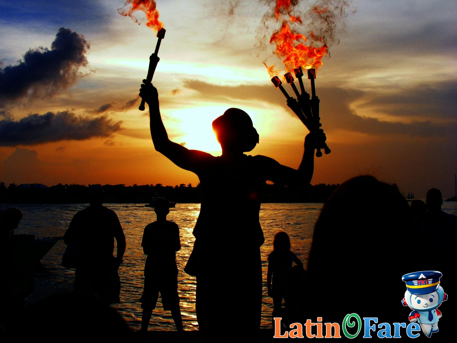 Sunset festival at Mallory Square Key West beach with colorful sky and street performers entertaining visitors.
