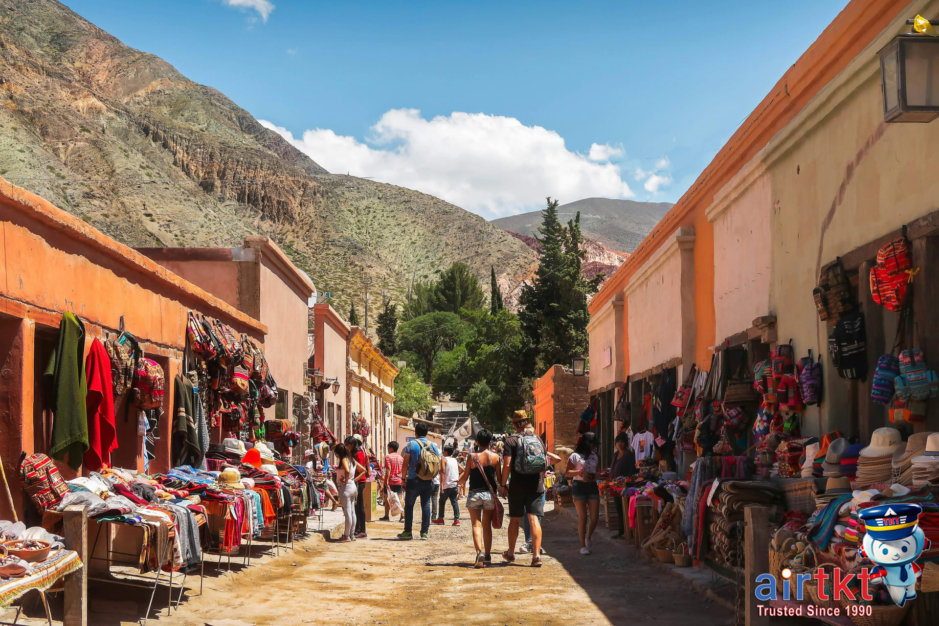 Tourists supporting local businesses by shopping at a vibrant local market