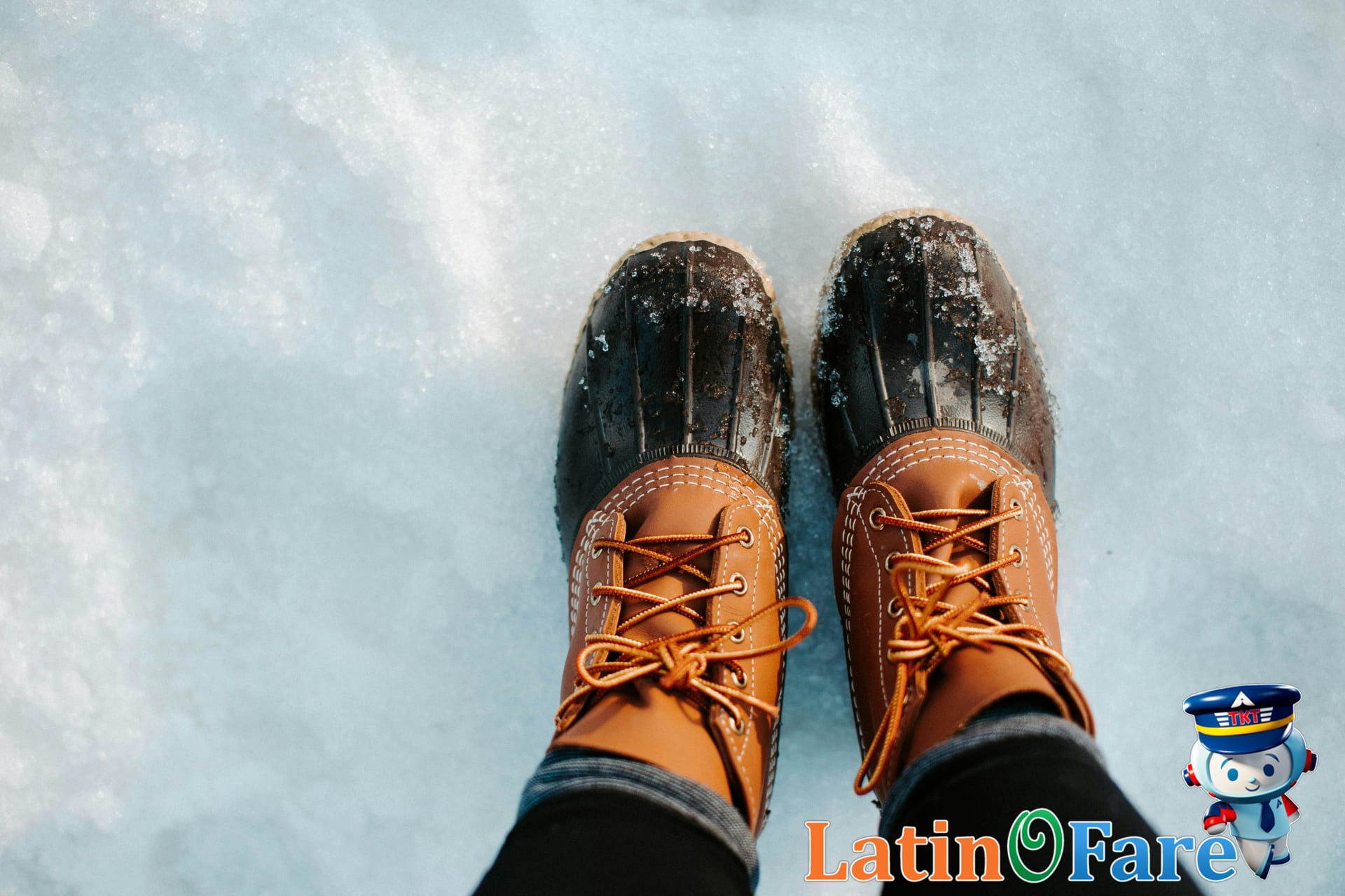 Close-up of winter boots standing on fresh snow. Ideal for cold weather outdoor packing.