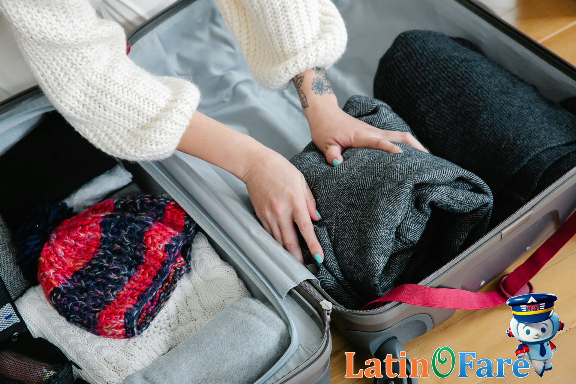 Suitcase packed with winter clothing, boots, and scarves for cold-weather travel.