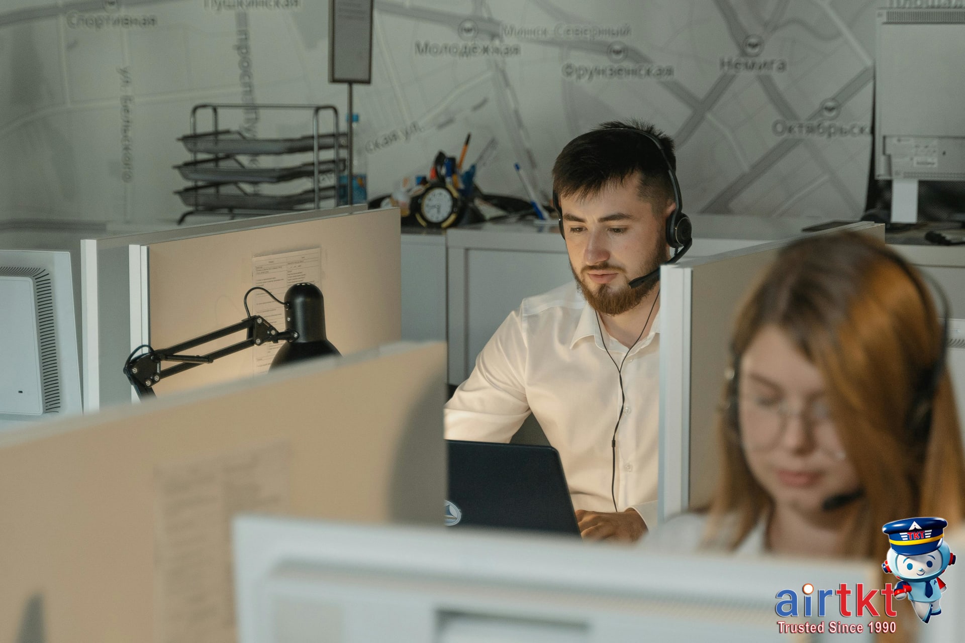 Travel expert discussing flight booking options with a traveler using VPN in a modern support center