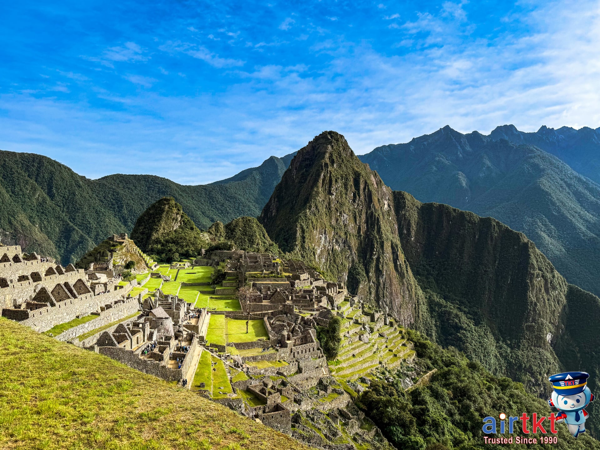 Breathtaking Machu Picchu ruins nestled in Peruvian mountains, with tourists exploring the ancient site