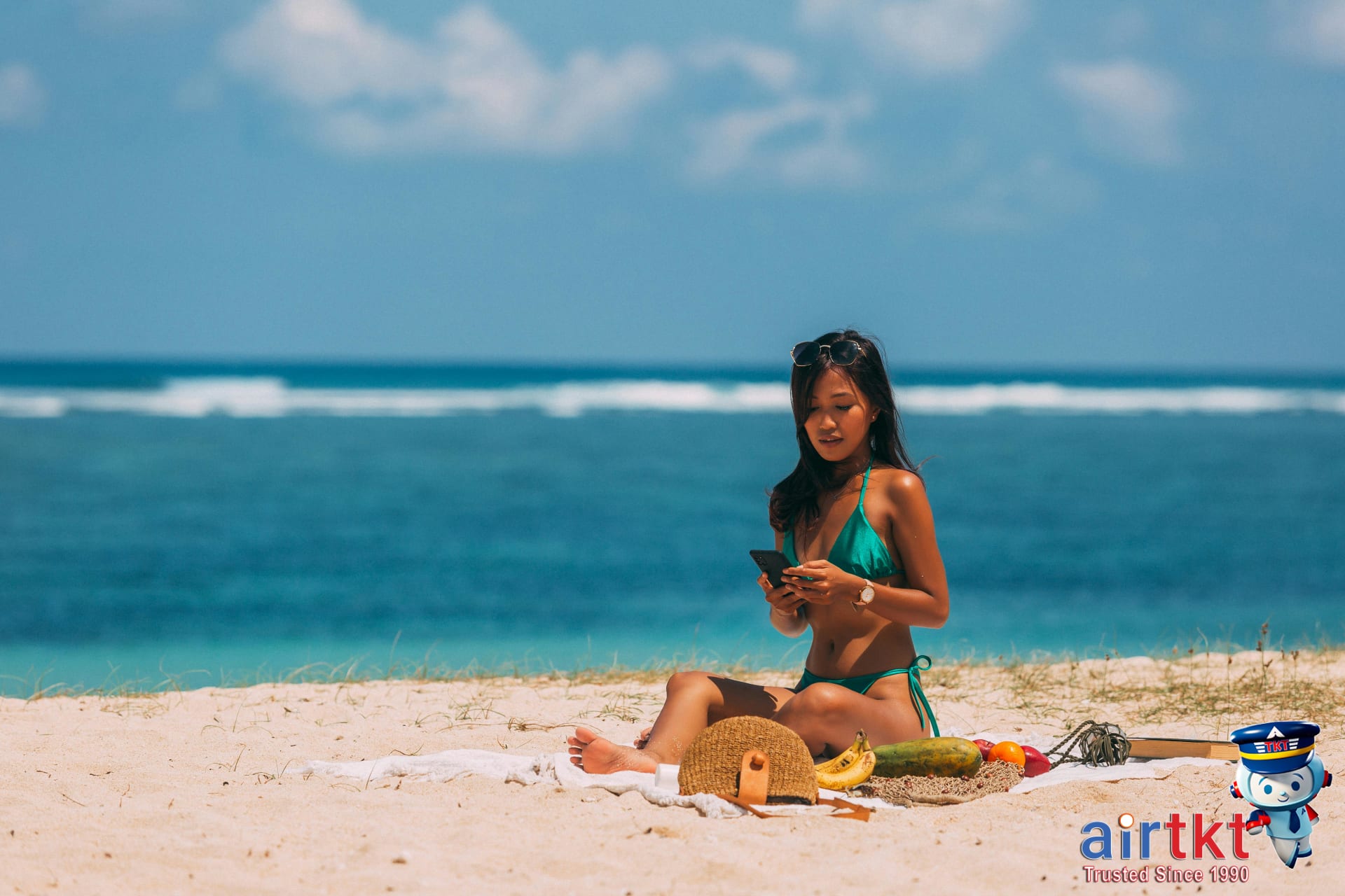 Traveler checking tropical beach packing list on smartphone for vacation