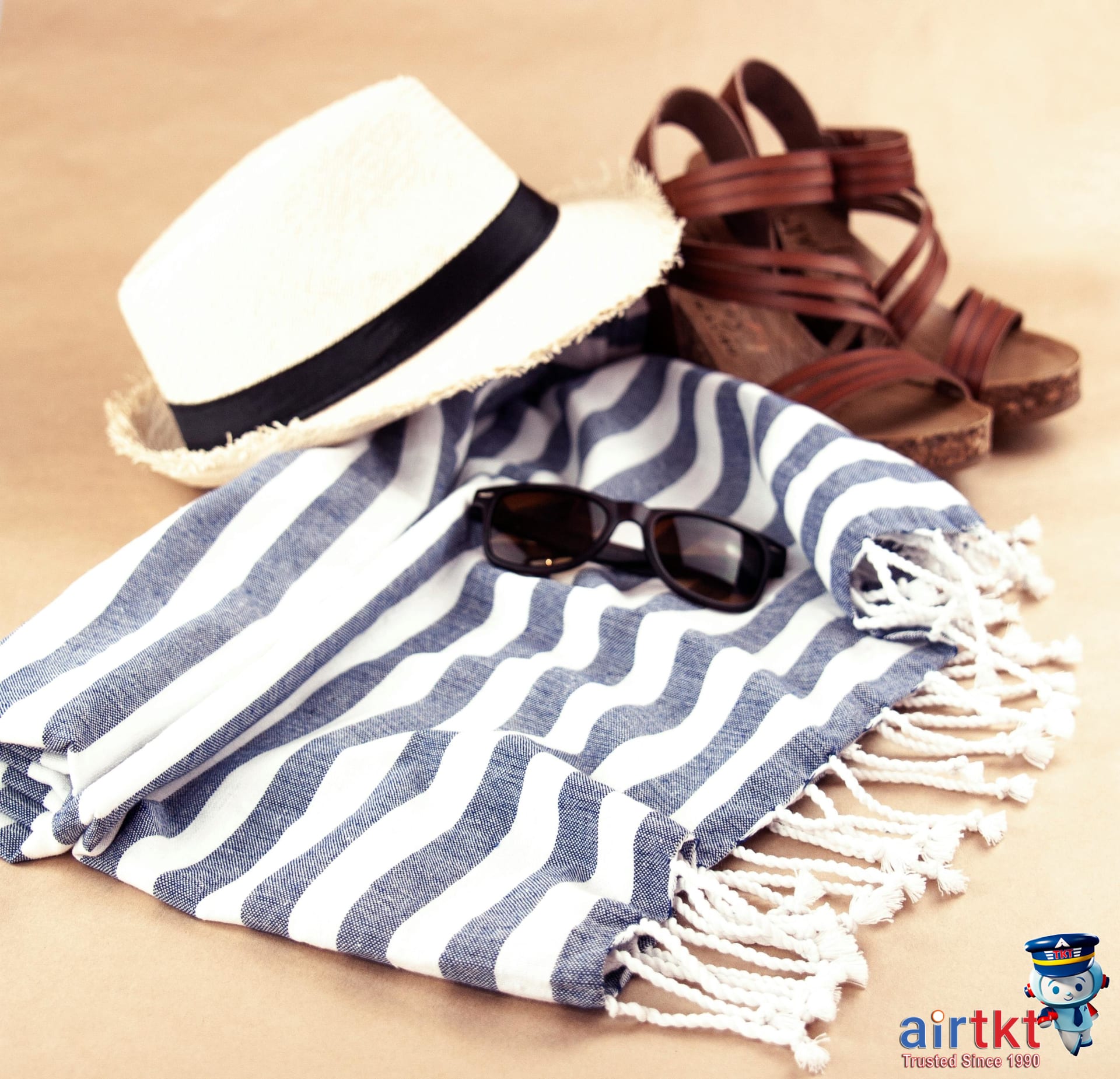Beach hat sunglasses and sarong laid out seaside on oceanfront chair