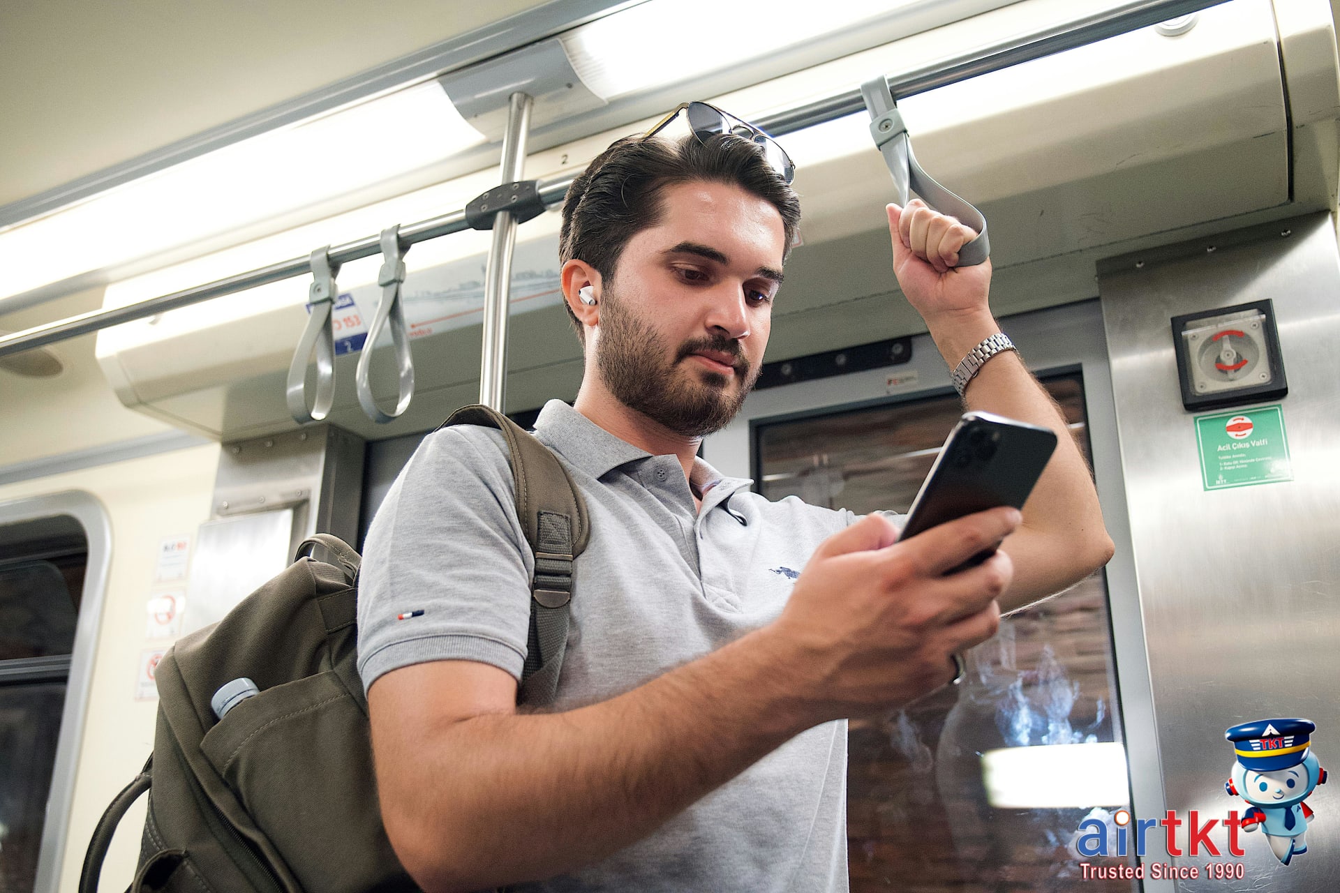 Traveler reviewing Eurail pass FAQ information on smartphone device