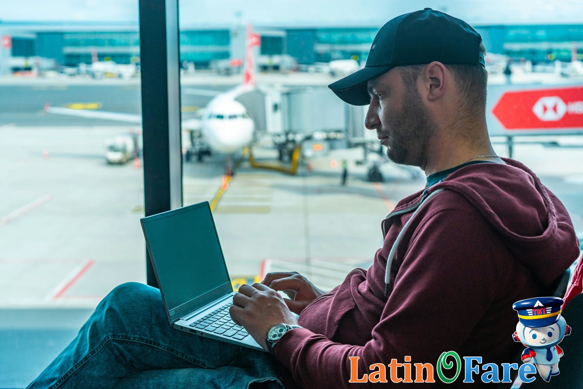 Man using laptop to redeem Capital One Venture X miles for travel savings online.