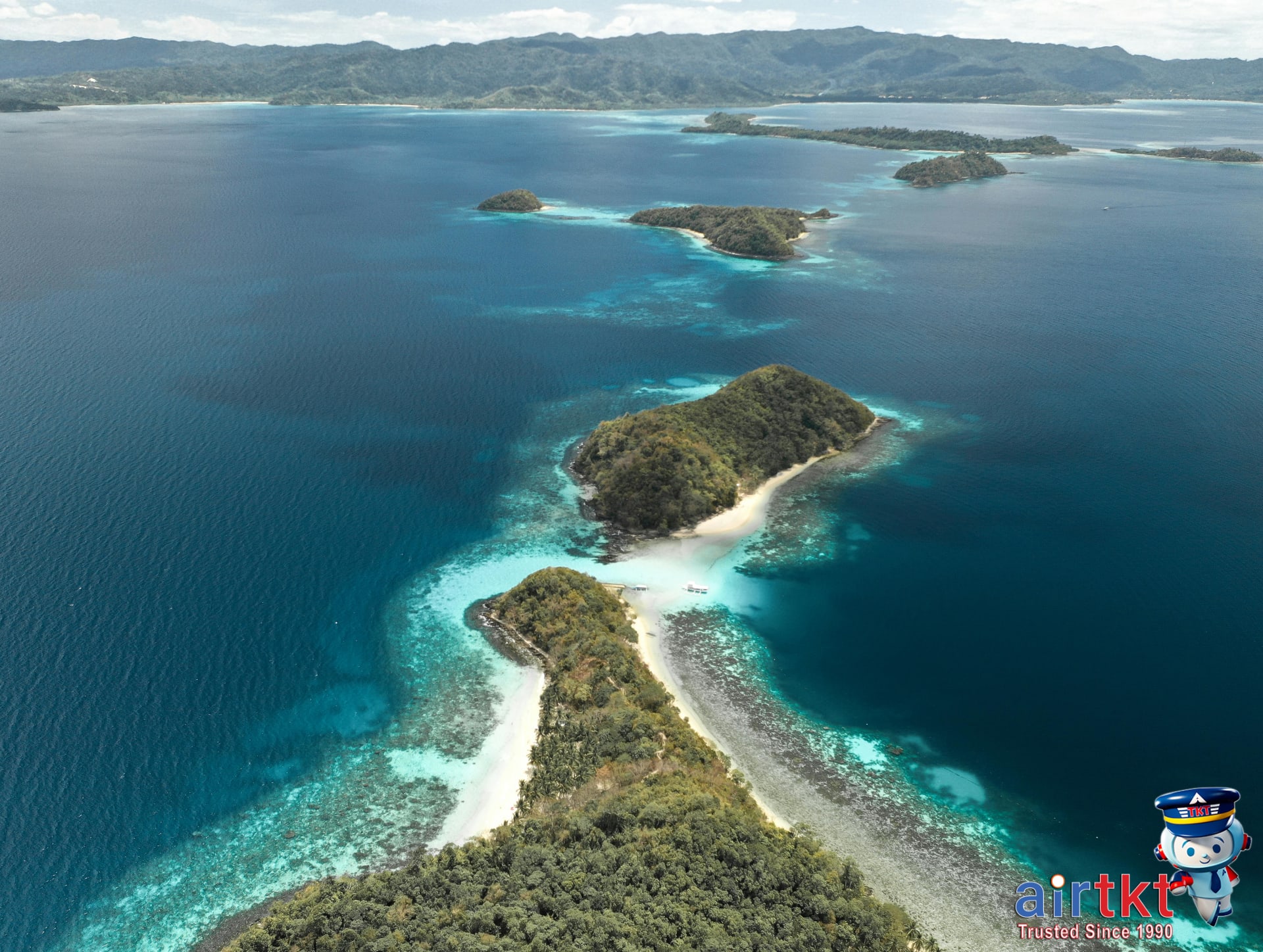 Aerial view of scattered tropical islands in the Philippines' ocean, showing beaches