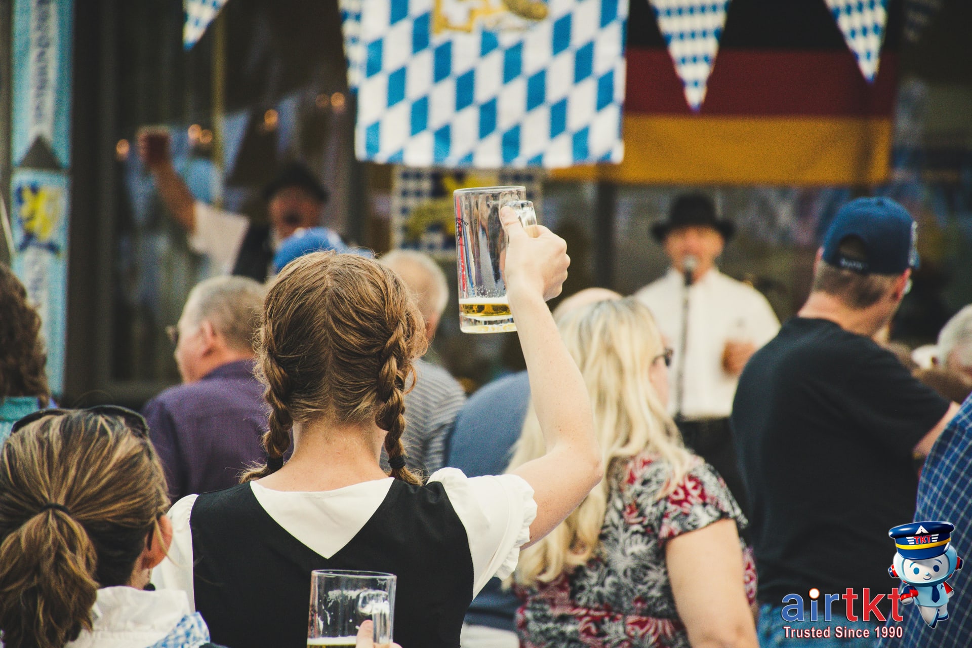 Oktoberfest beer steins cheers and crowd etiquette in Munich festival, showing lively festivalgoers