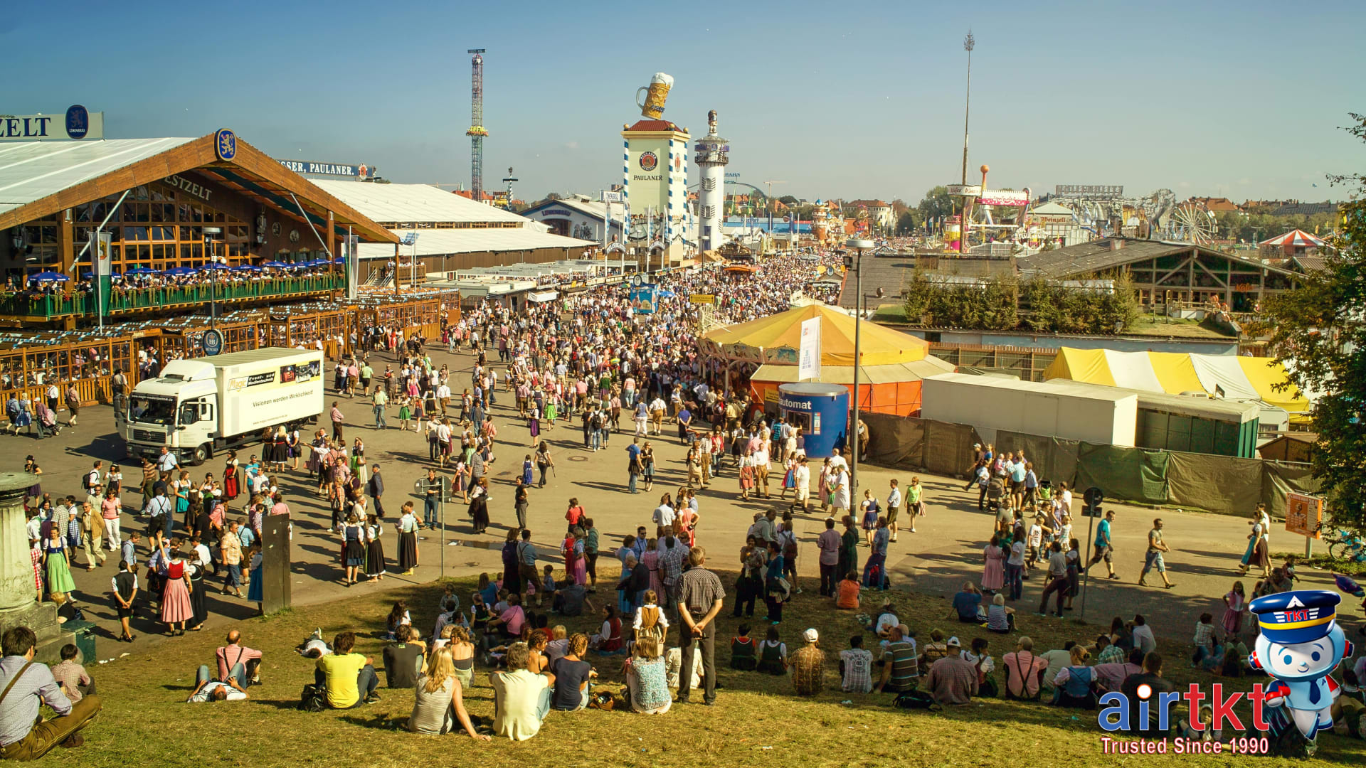Public transport and crowd flows at Munich Oktoberfest beer festival grounds with trams and U-Bahn signs visible