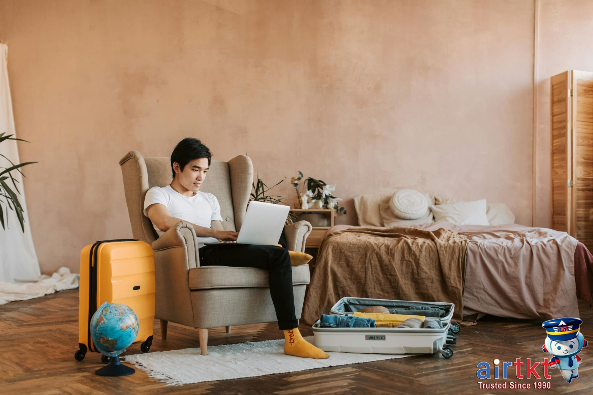 Booking tips for all-inclusive resorts traveler using laptop for reservations