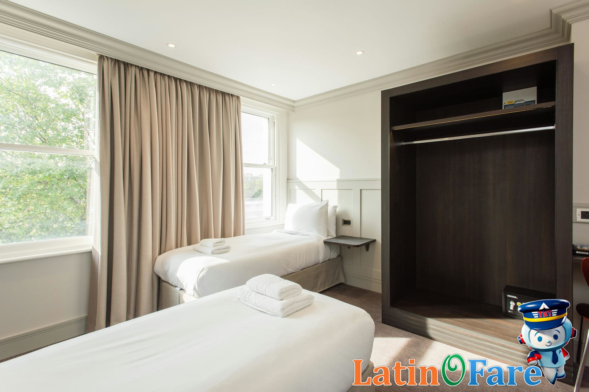 Bright twin hotel room with contemporary design in London, demonstrating comfort and rest quality