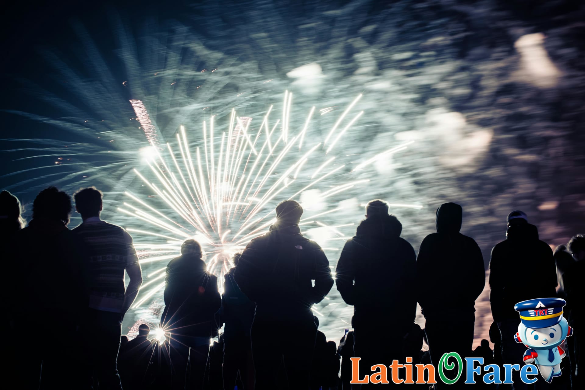 Crowd gathered along waterfront enjoying July 4th fireworks show in top U.S. travel destination.