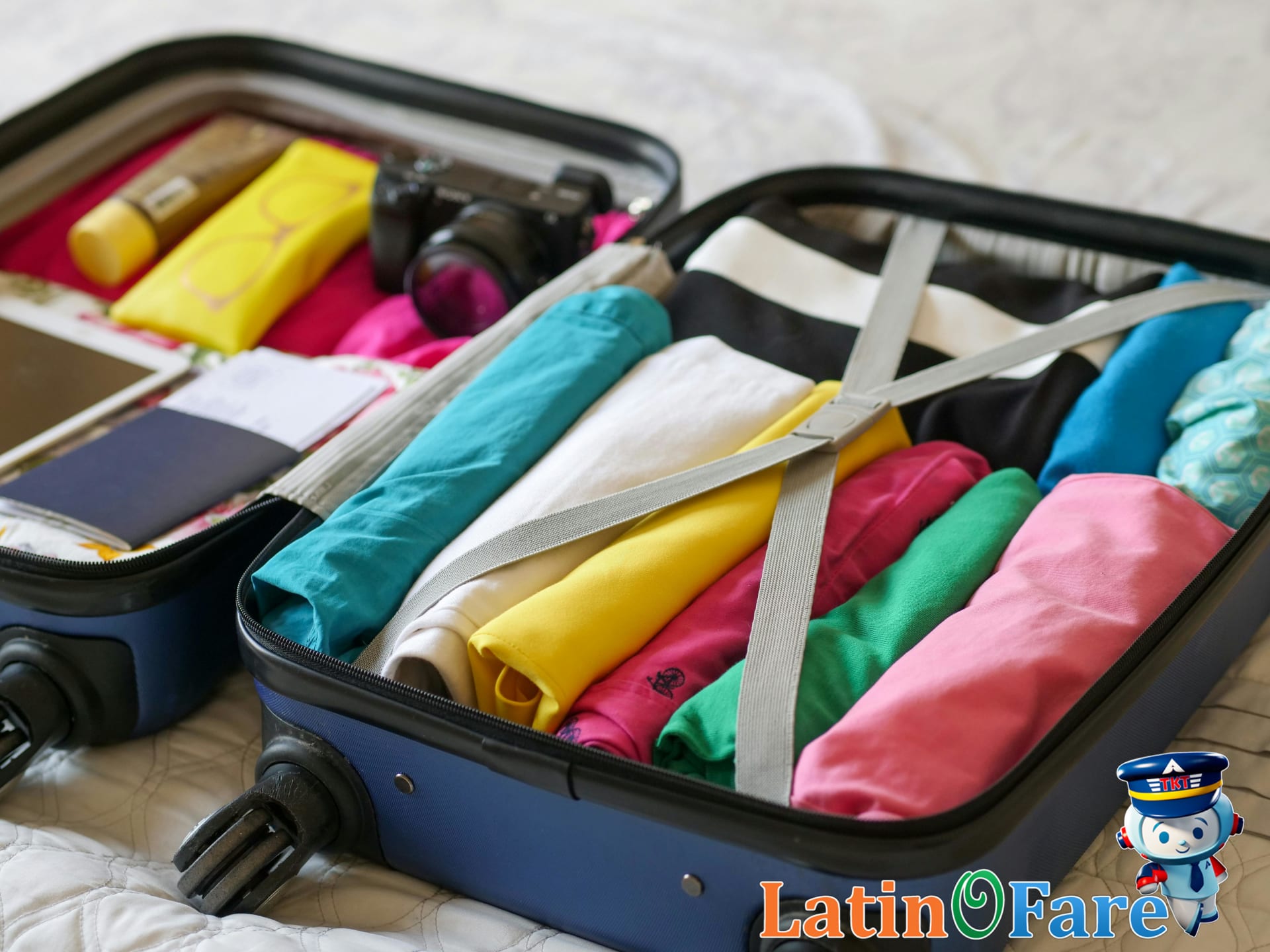 Packed suitcase prepared with safety essentials and American-themed attire for July 4th travel.