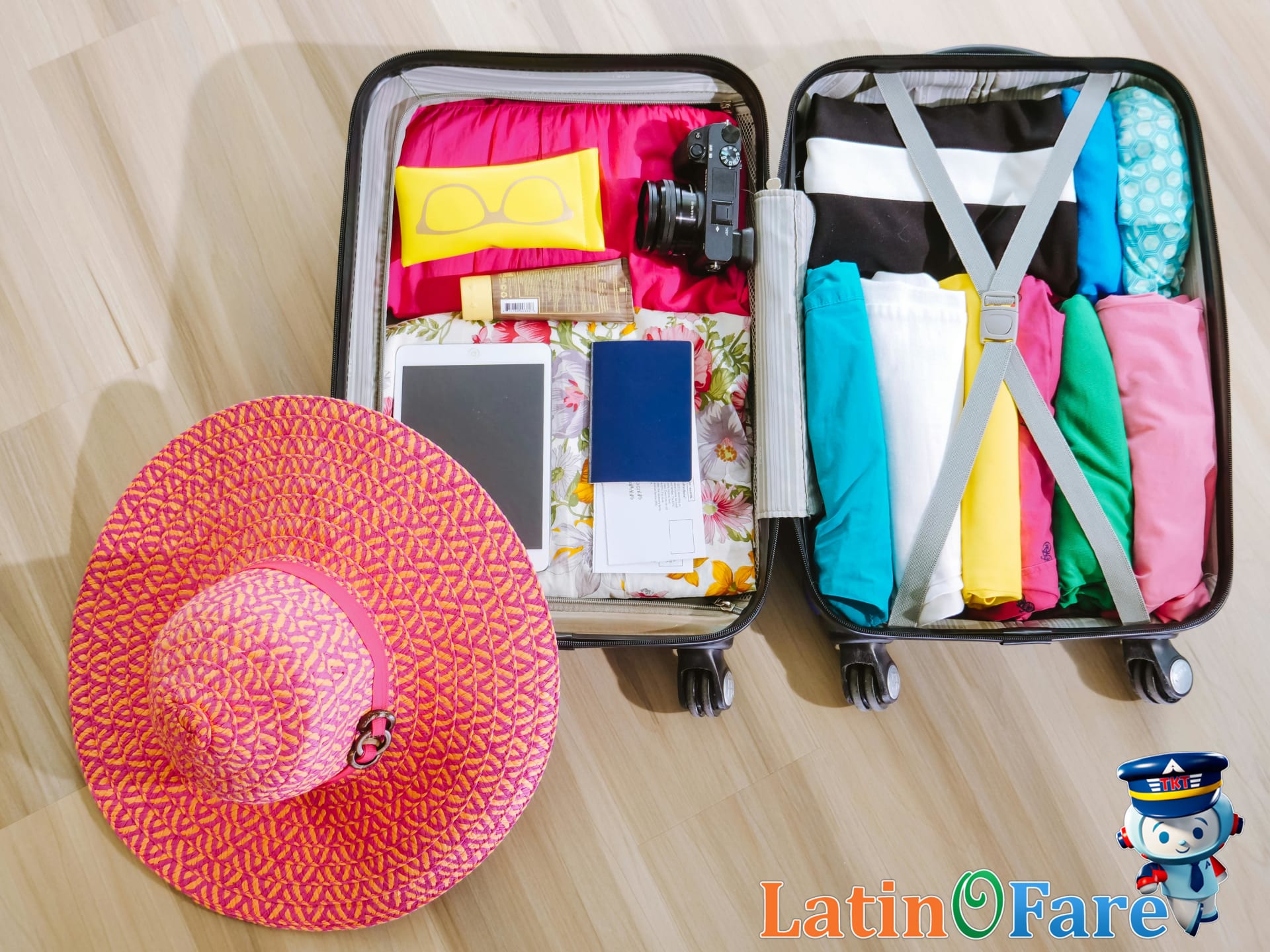 Suitcase packed with camera and summer essentials for a memorable and well-planned Fourth of July trip.