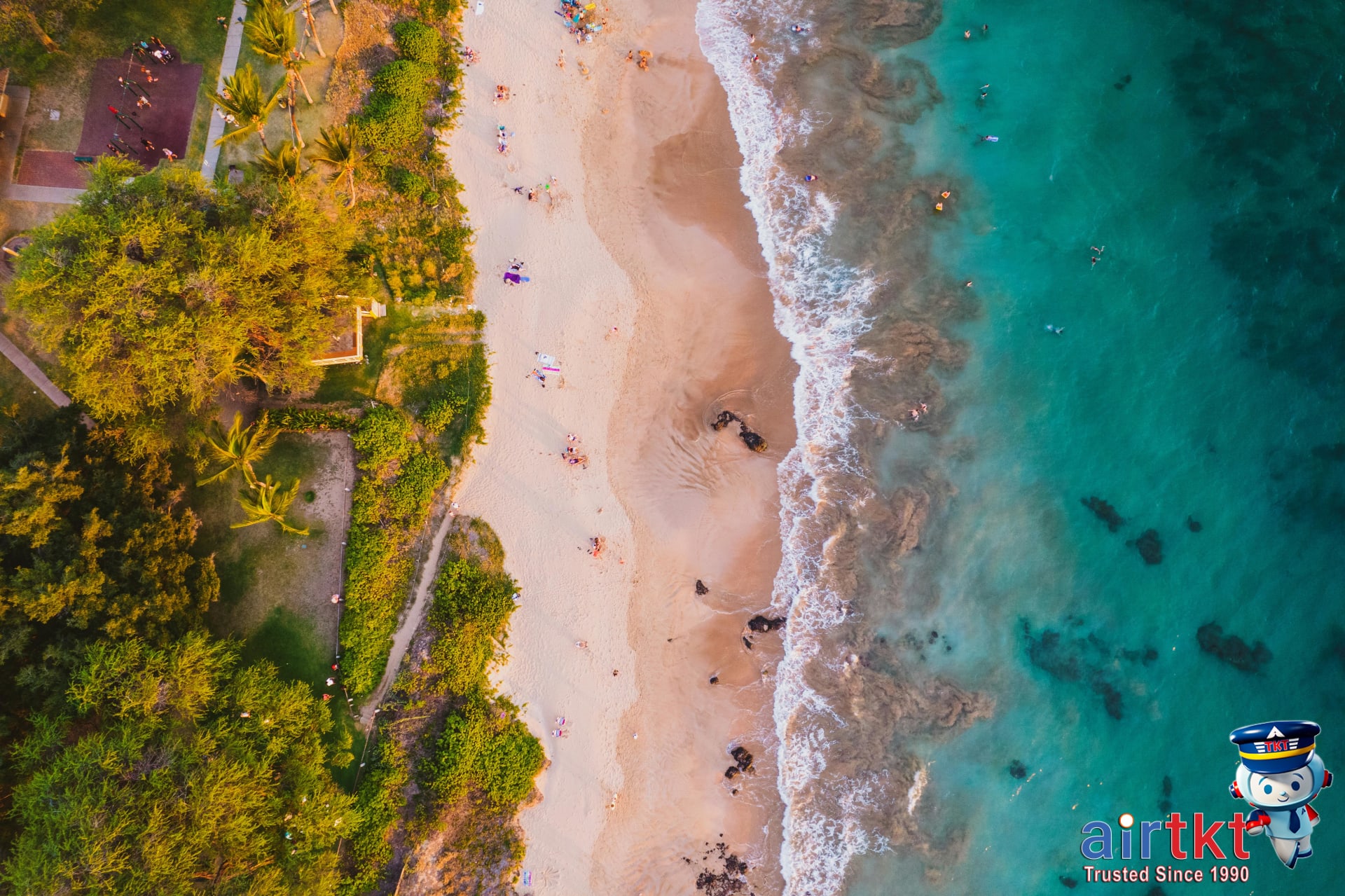 Pristine white sand Maui beaches with palm trees and crystal clear water