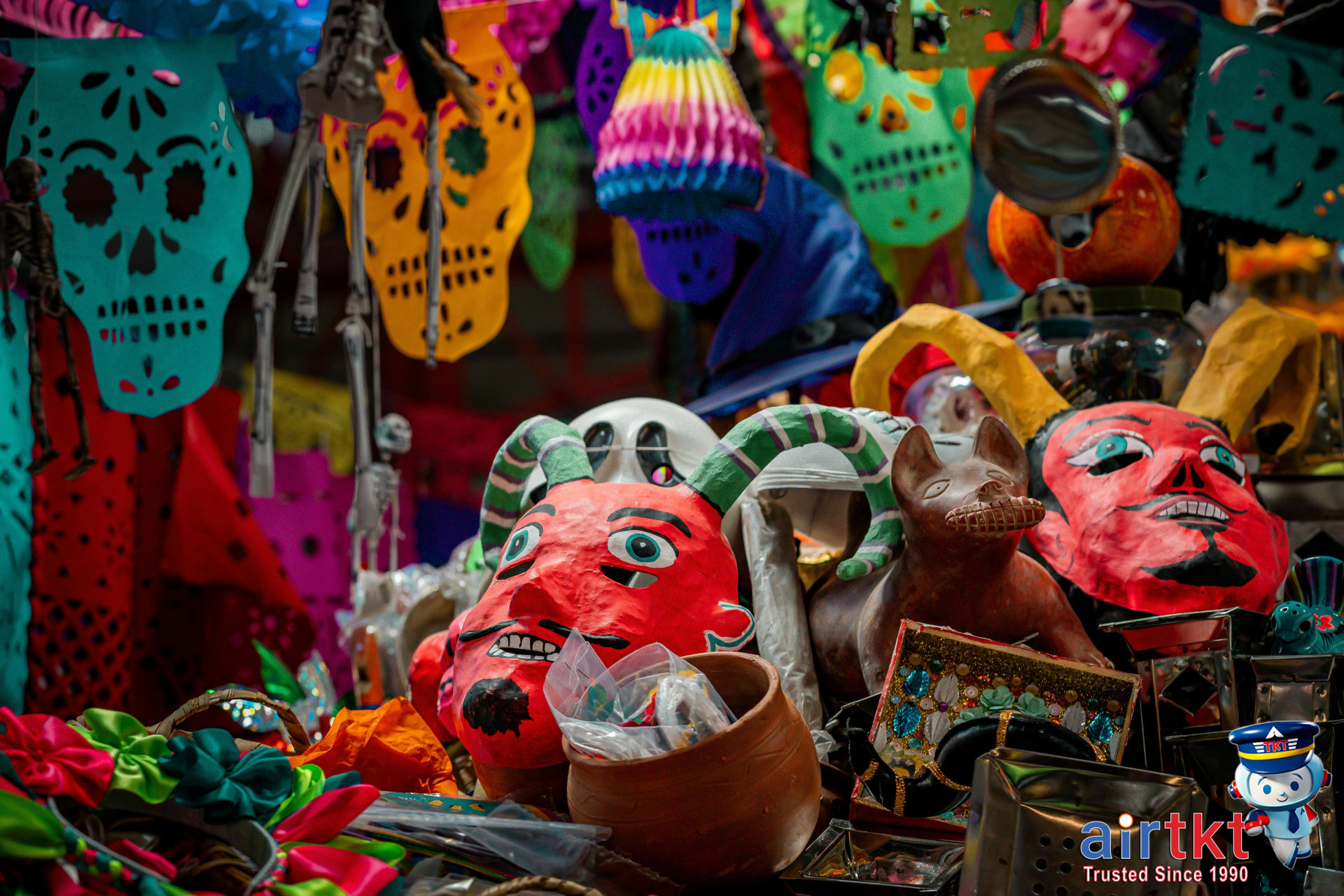 Traditional papel picado decorations for Día de Muertos festival hang above a street