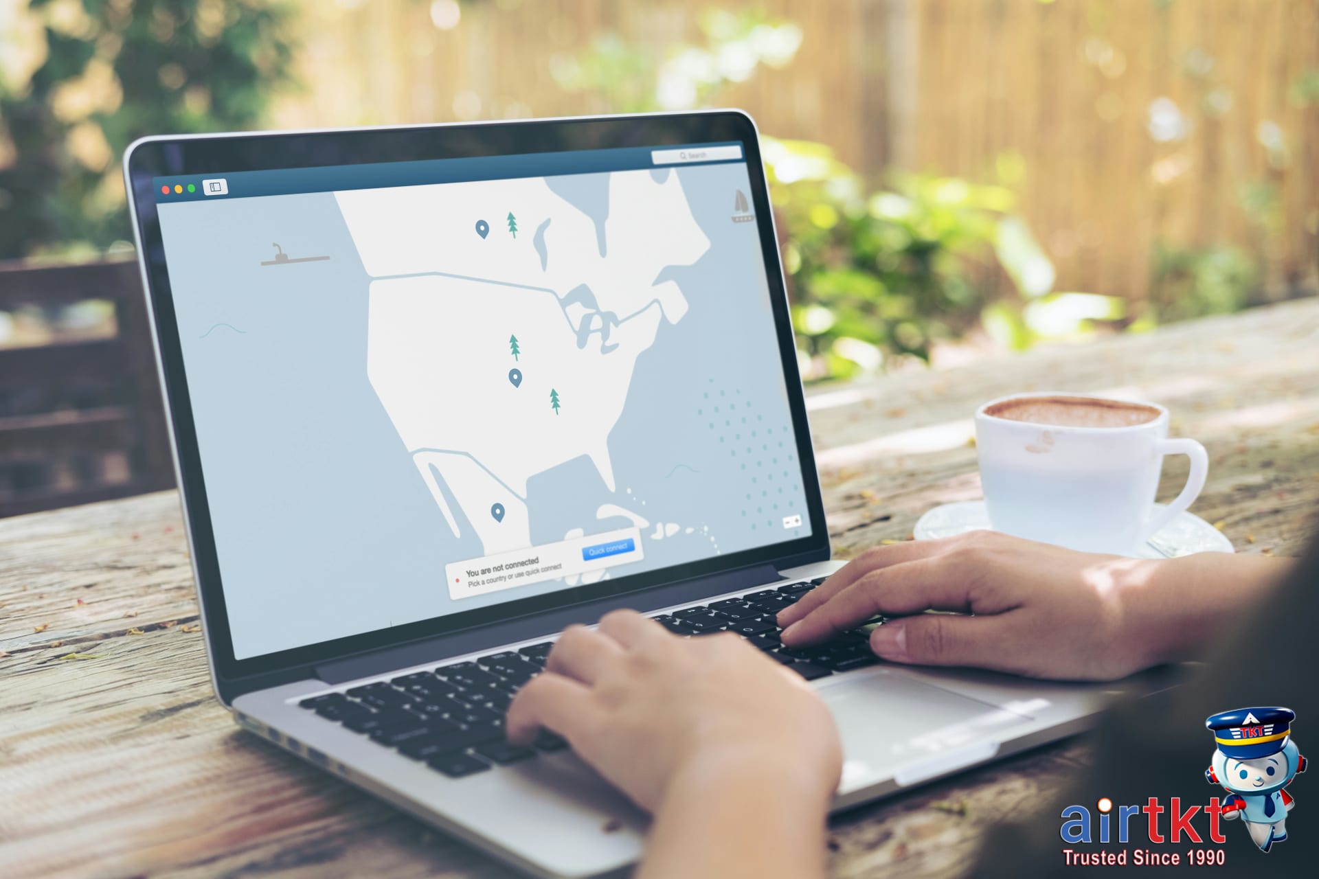 Traveler using a laptop comparing VPN options for travel safety in a hotel room