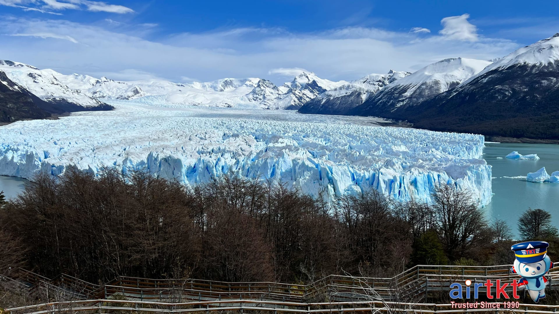 Tourists viewing massive blue Perito Moreno Glacier from walkway