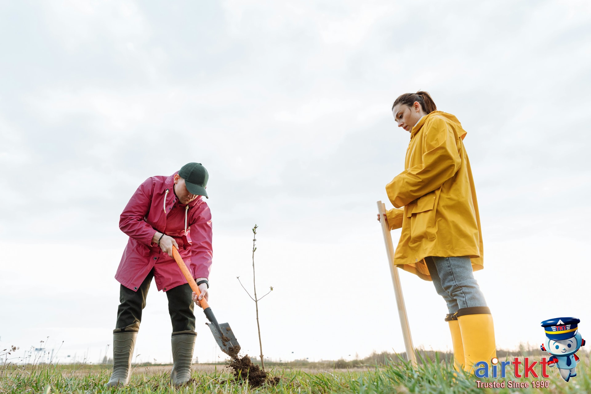 Tourists engaging in sustainable travel practices planting trees in community
