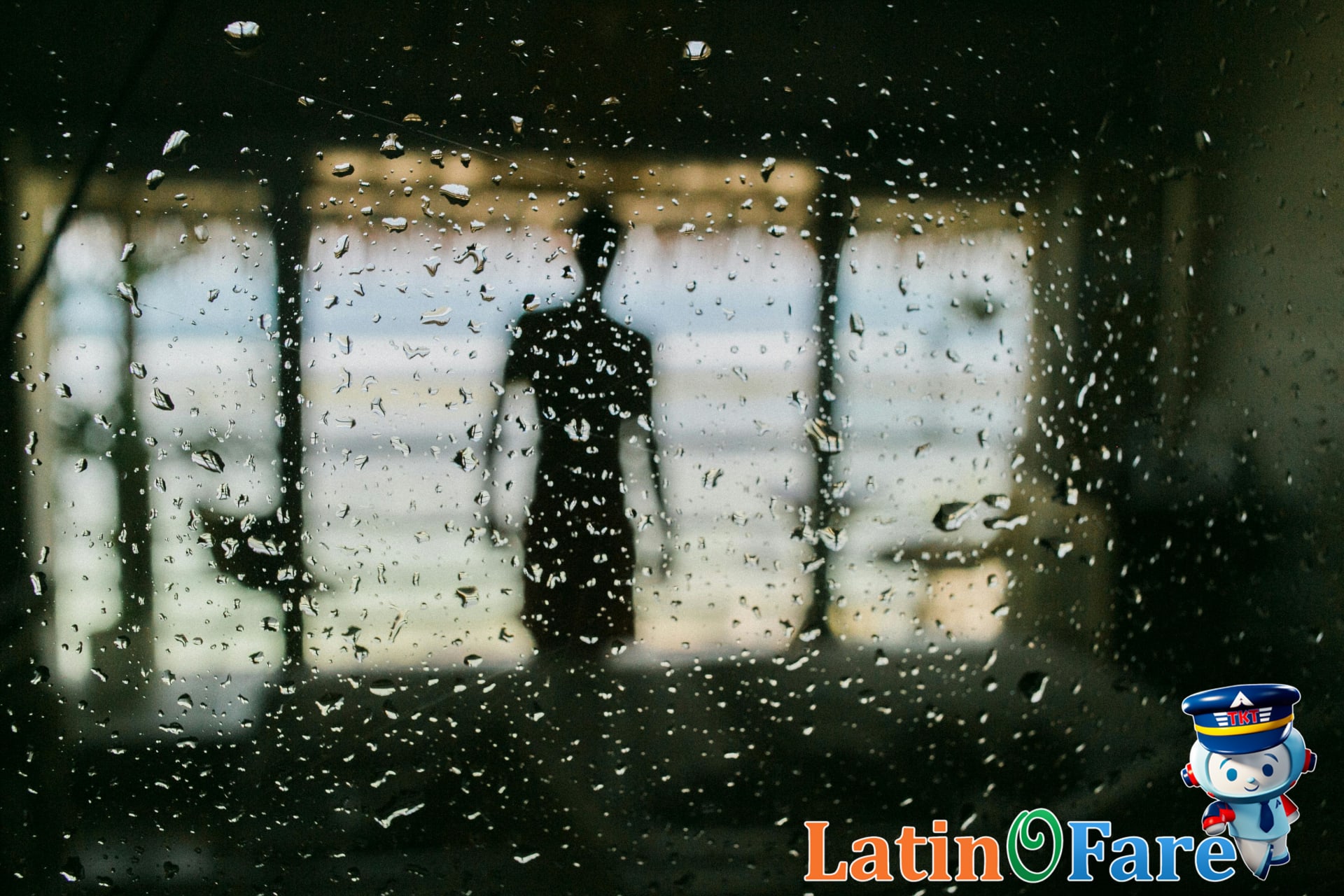 Rainy Caribbean hotel view during hurricane season travel with window raindrops, 13 words, includes keyword variant.