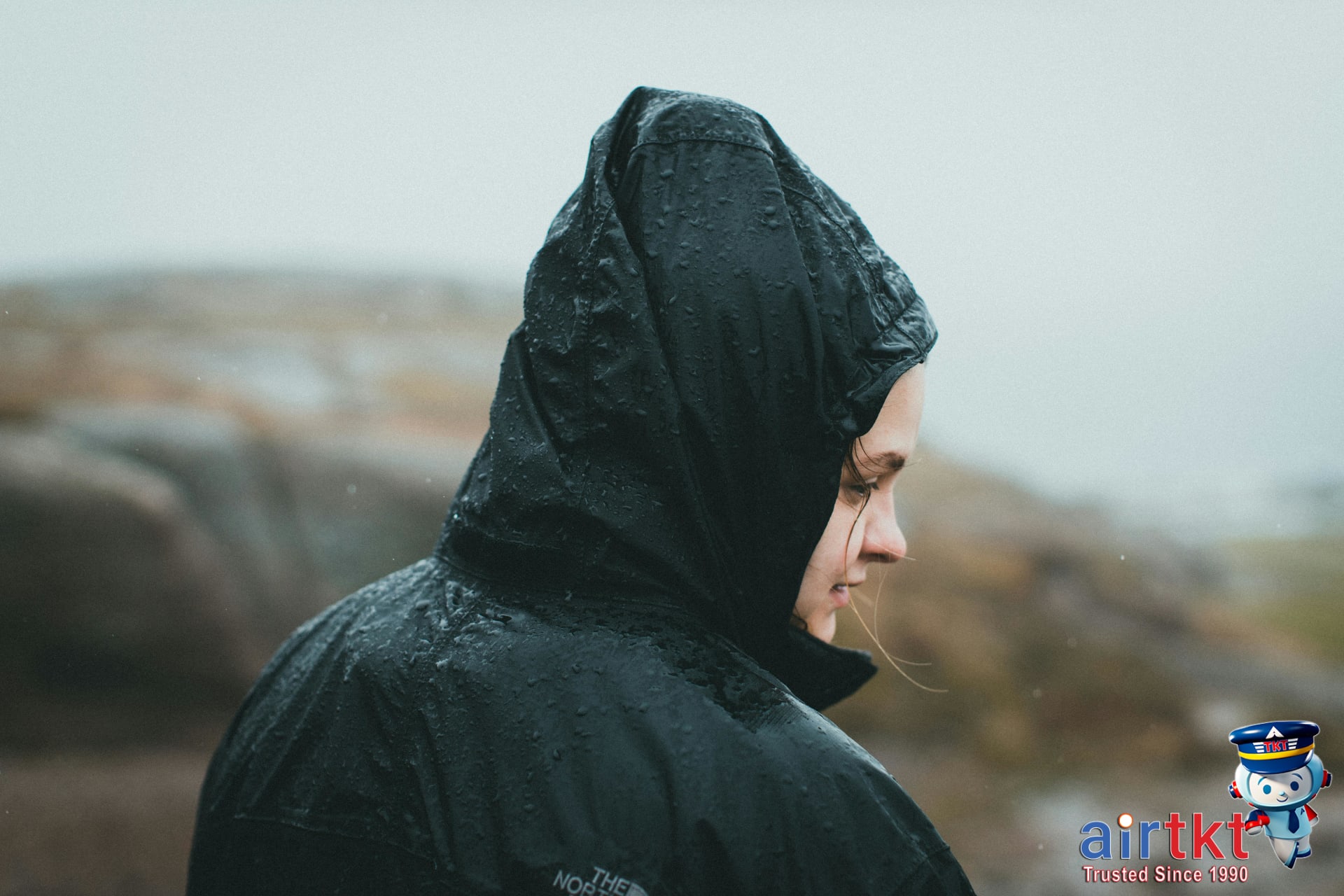 Traveler prepared for Costa Rica rainy season with waterproof yellow rain jacket