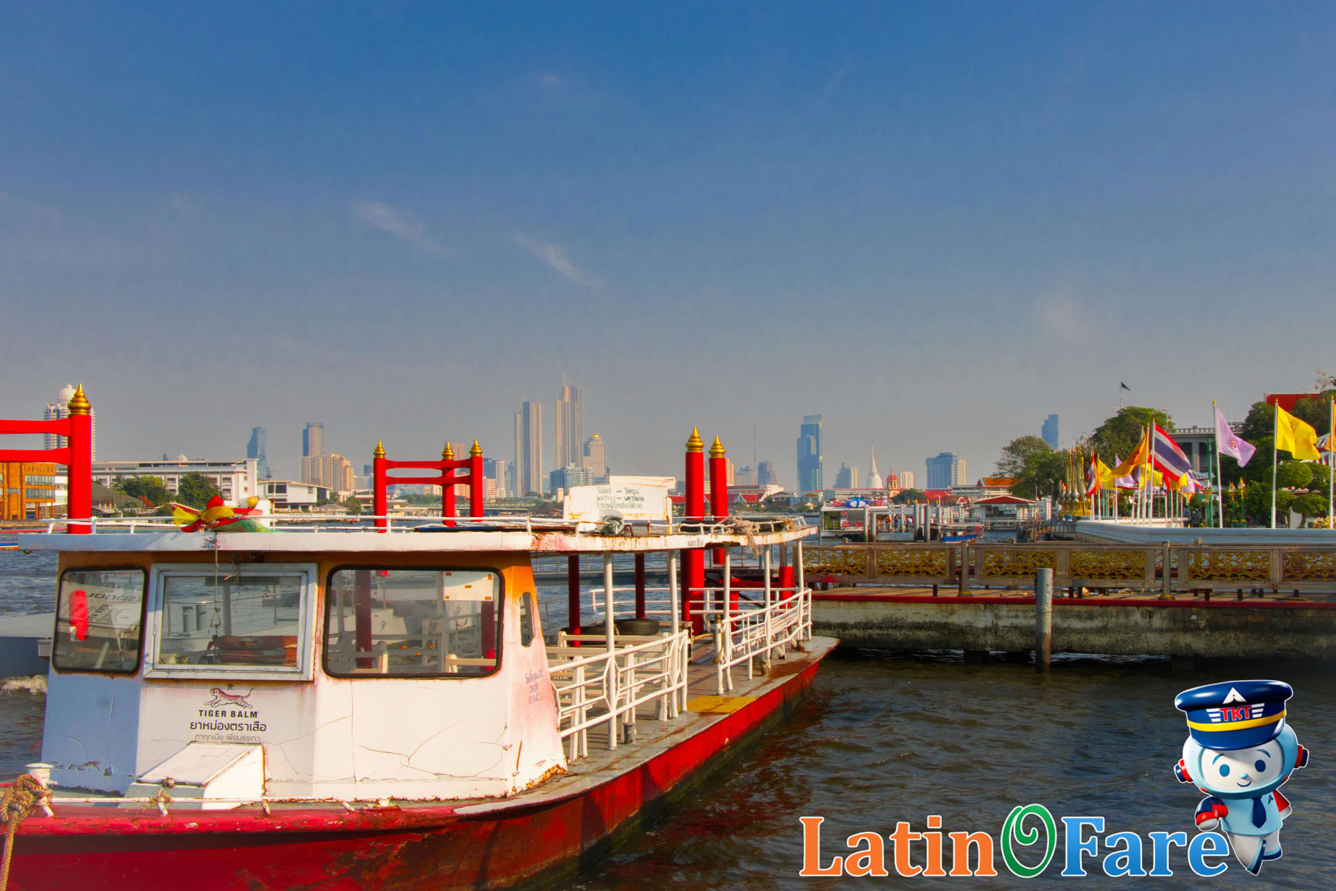 Chao Phraya river boat docking at Sathorn Pier with travelers boarding for central Bangkok attractions.