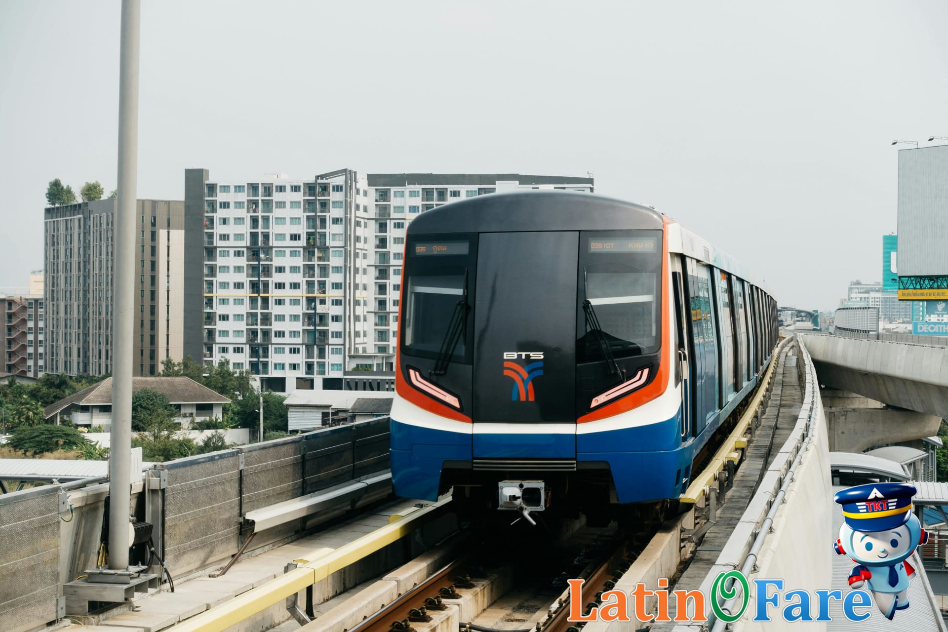 Inside Bangkok Skytrain carriage filled with local commuters and tourists traveling on BTS lines.