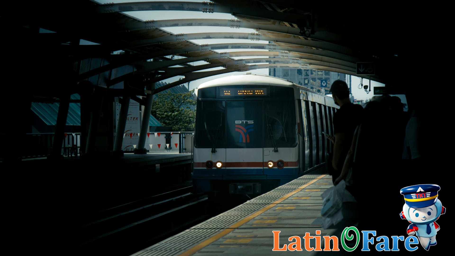 Bangkok commuters crowding onto a BTS Skytrain train at morning rush for easy city travel.