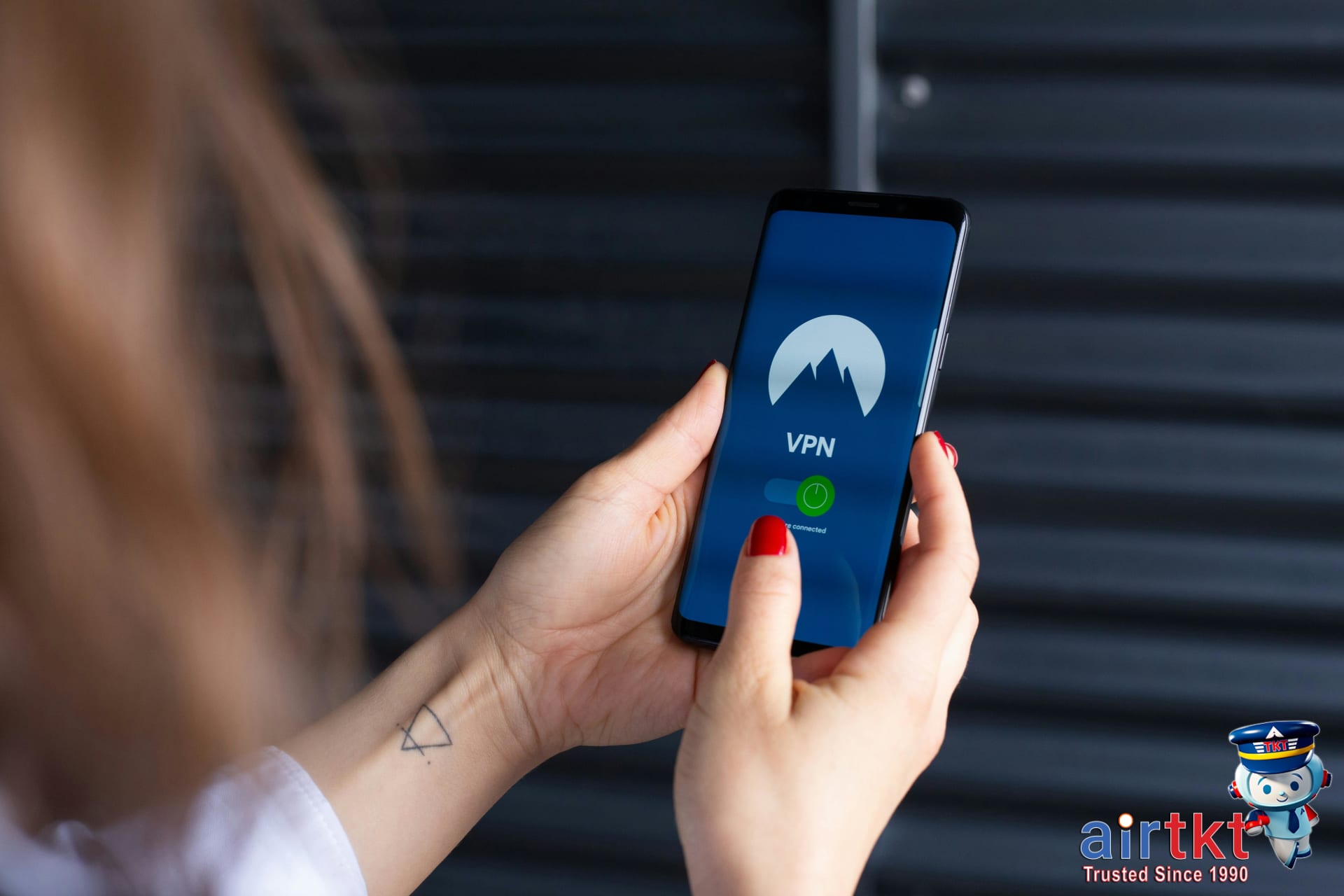 Solo female traveler protecting phone privacy in public using phone