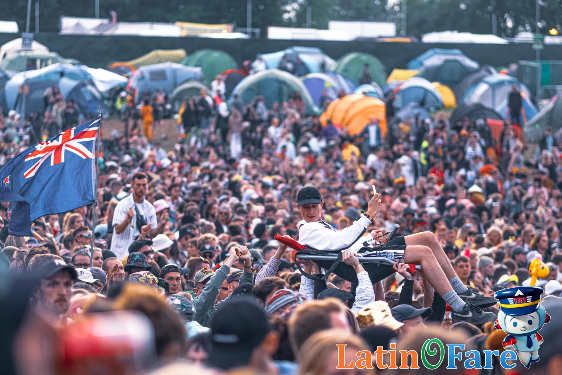 Festival crowd viewed from shoulder level, illustrating alert pickpocket prevention in busy environments.