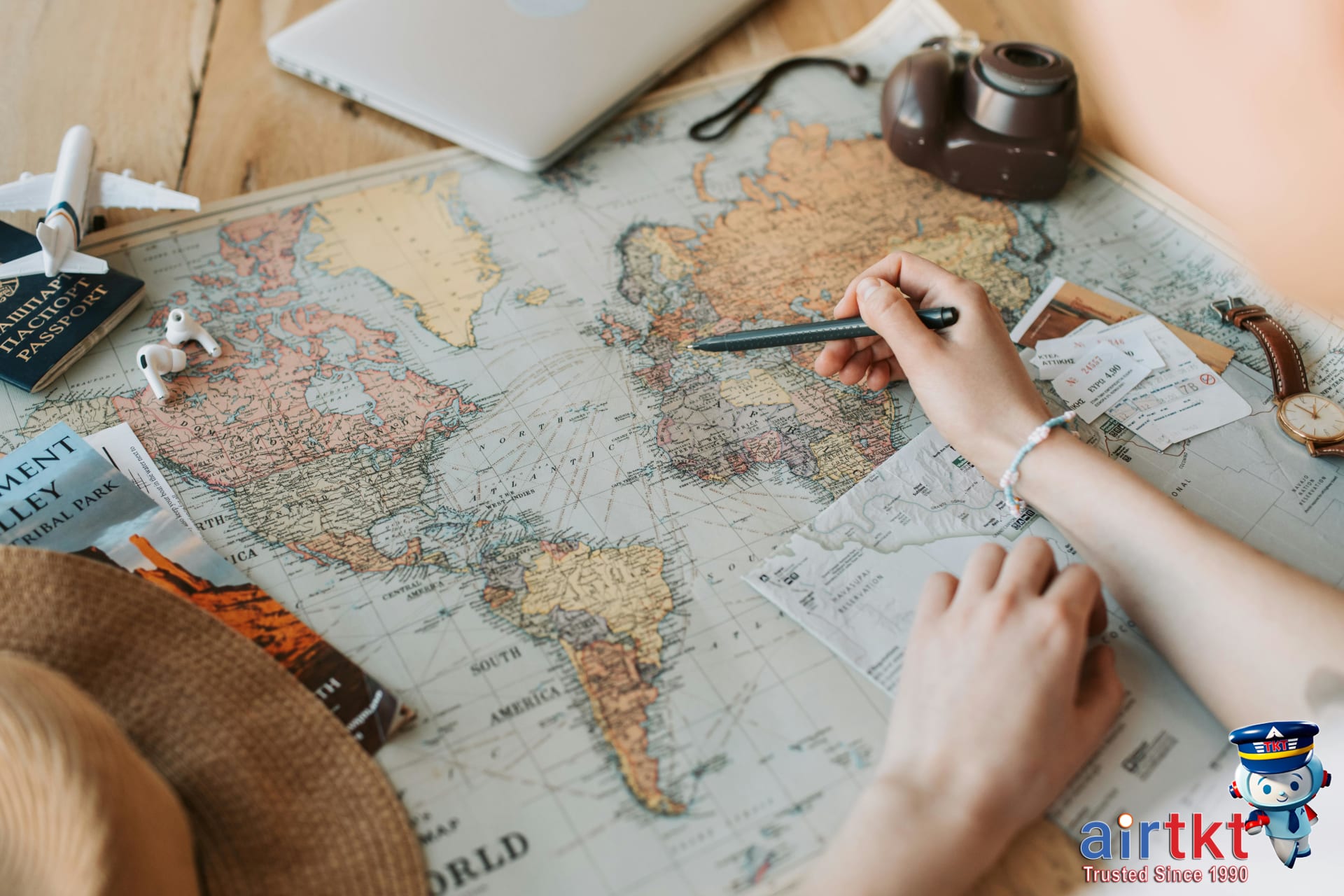 Traveler planning Japan itinerary with JR Pass, map, and train schedule on table