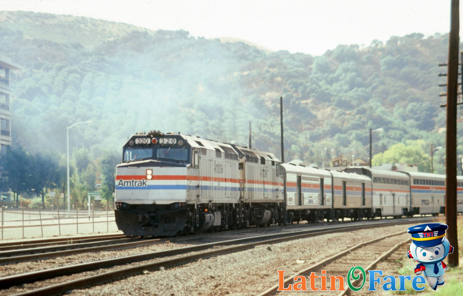 Amtrak train crossing USA landscape at sunset, showcasing cross-country rail travel.