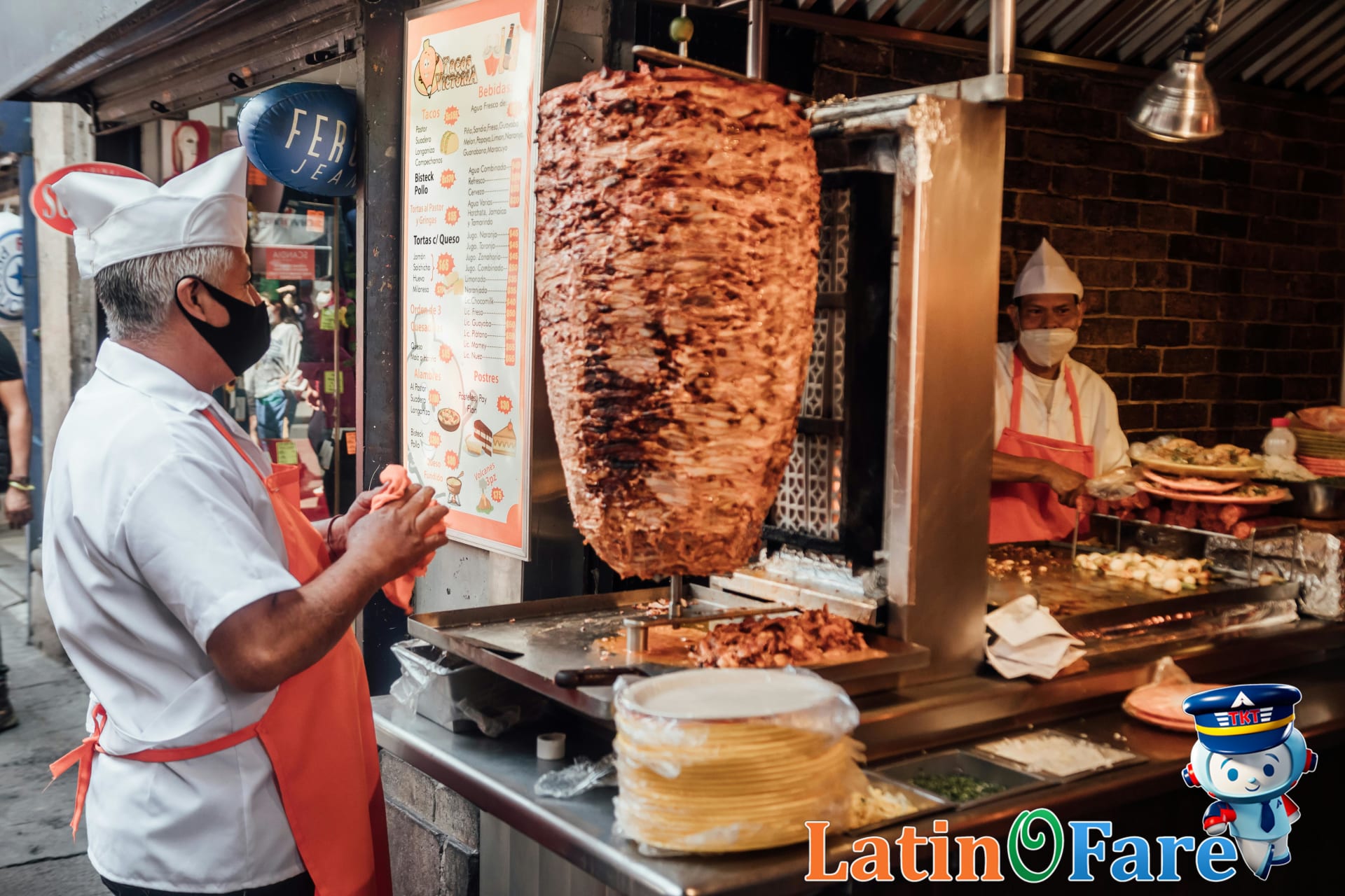 Street vendors prepare tacos al pastor at a famous Mexico City market food stand