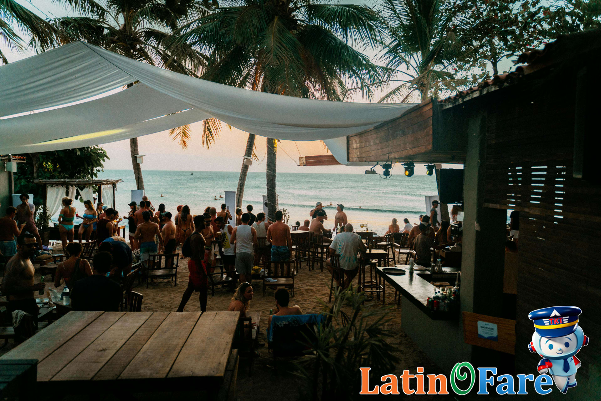 Cancun beach bar nightlife scene after sunset, lively with music, drinks, and glowing lights.