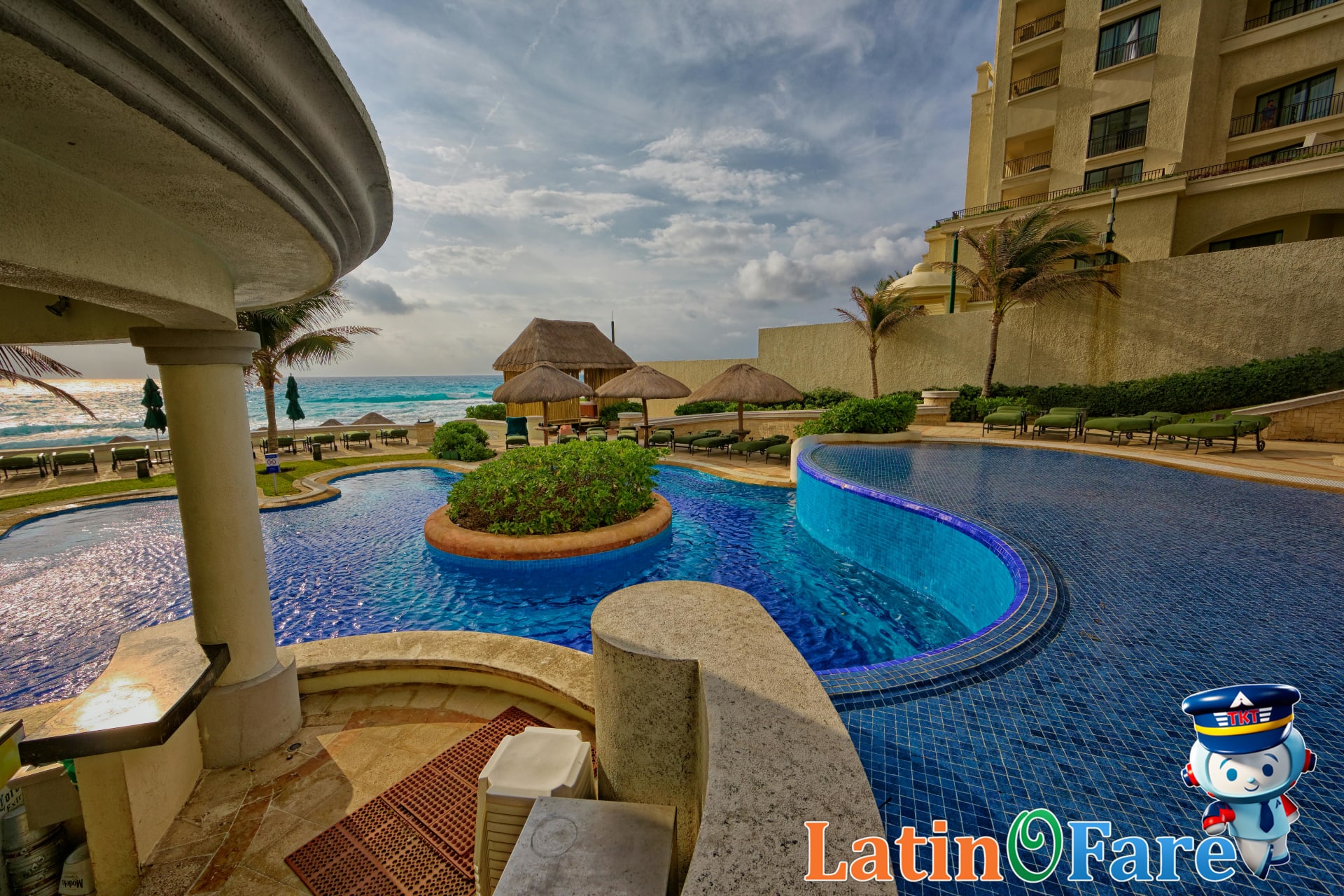All-inclusive resort poolside in Cancun with guests relaxing and deluxe oceanfront amenities.