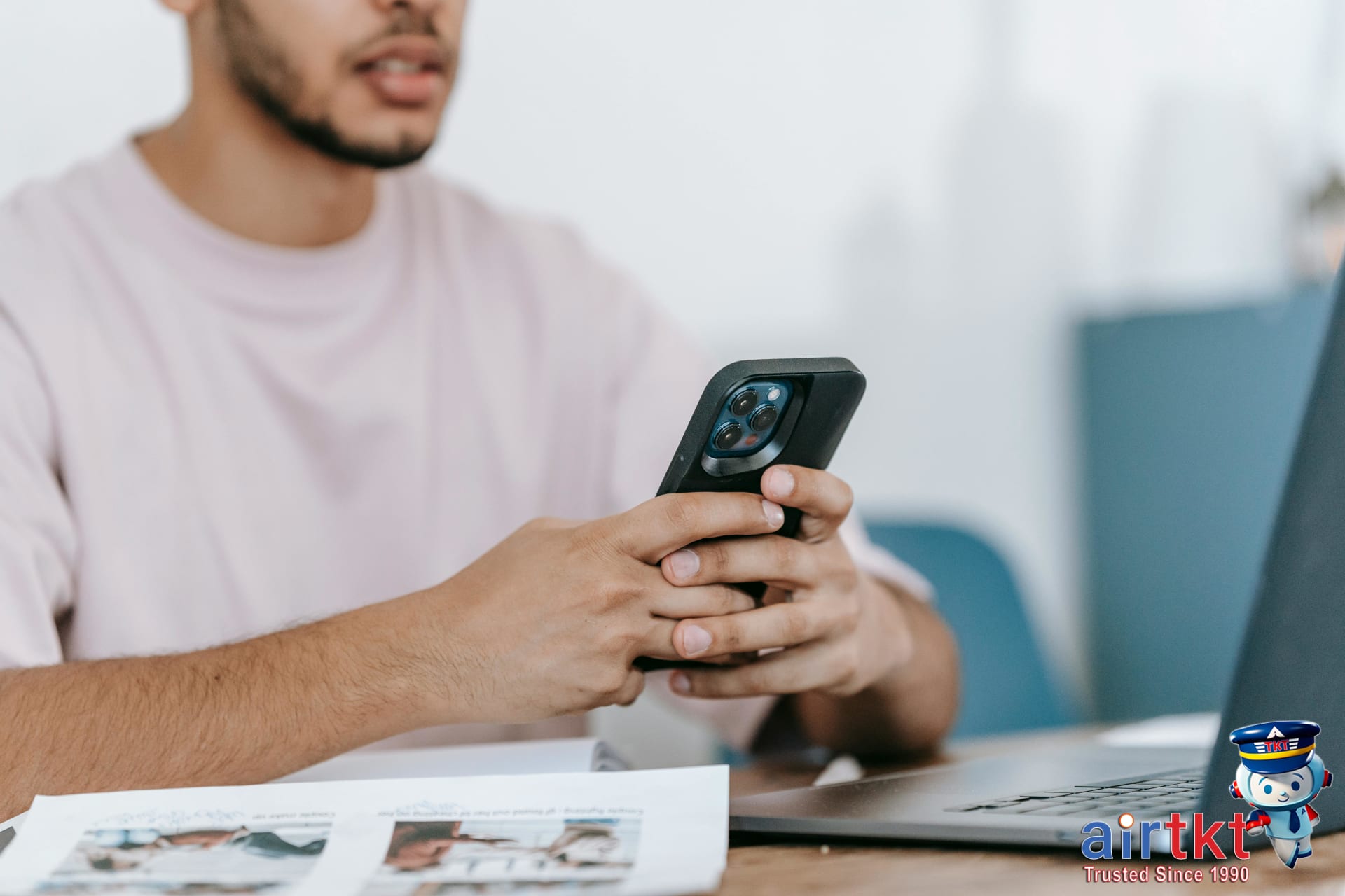 Traveler comparing eSIM and local SIM for travel data plans with smartphone and laptop